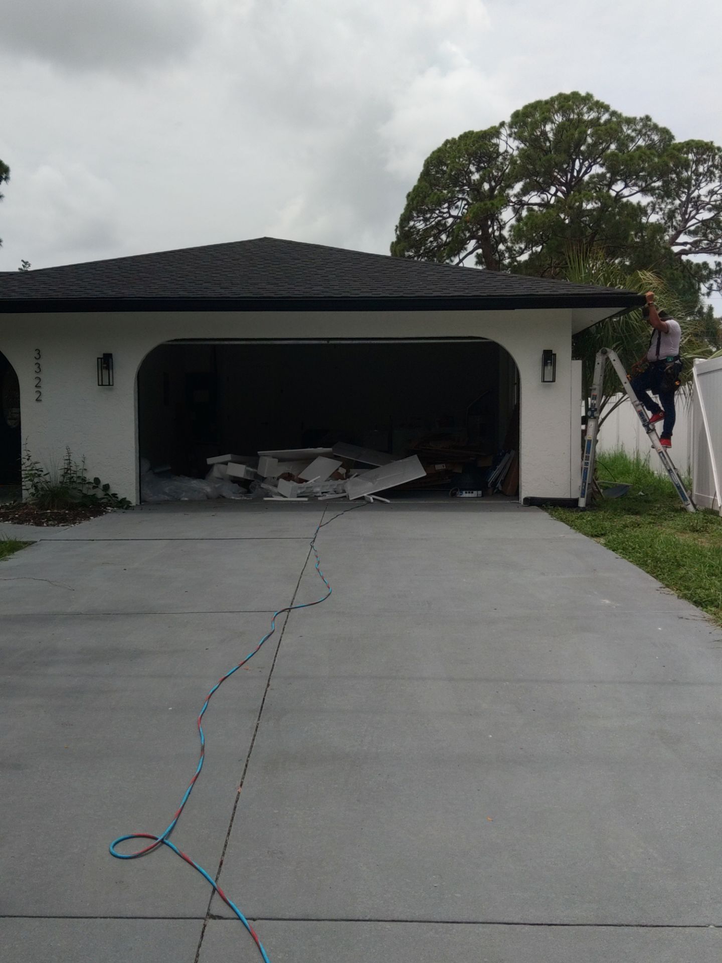 Black seamless gutters and downspouts installation in Sarasota, FL by Gutter Professors