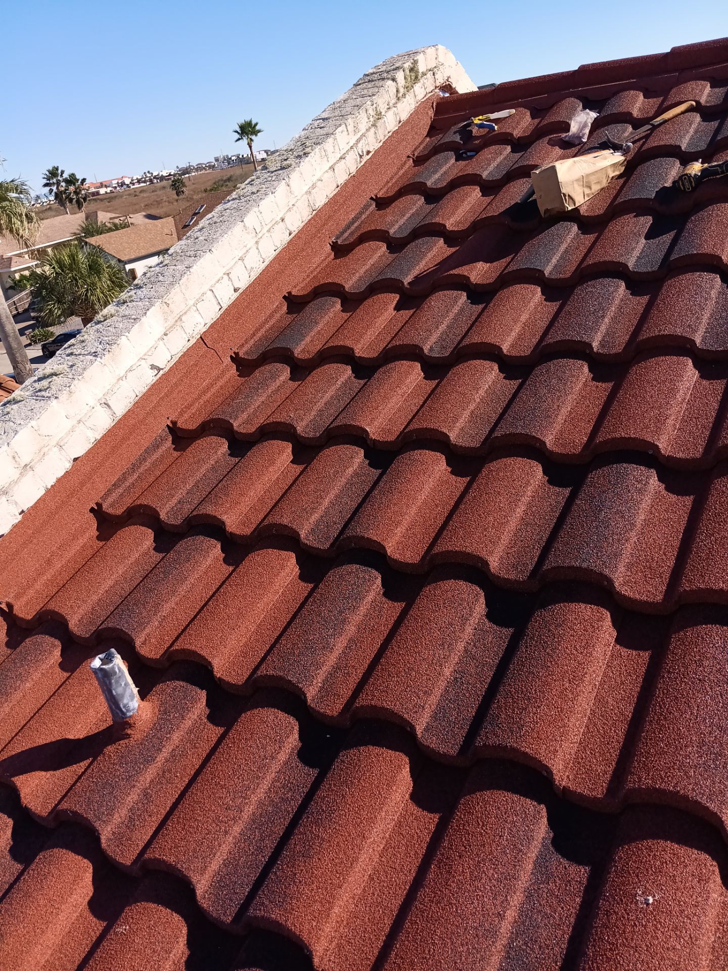 Off with the Tile and on with the TILCOR stone coated metal.  by Bayfront Roofing and Construction