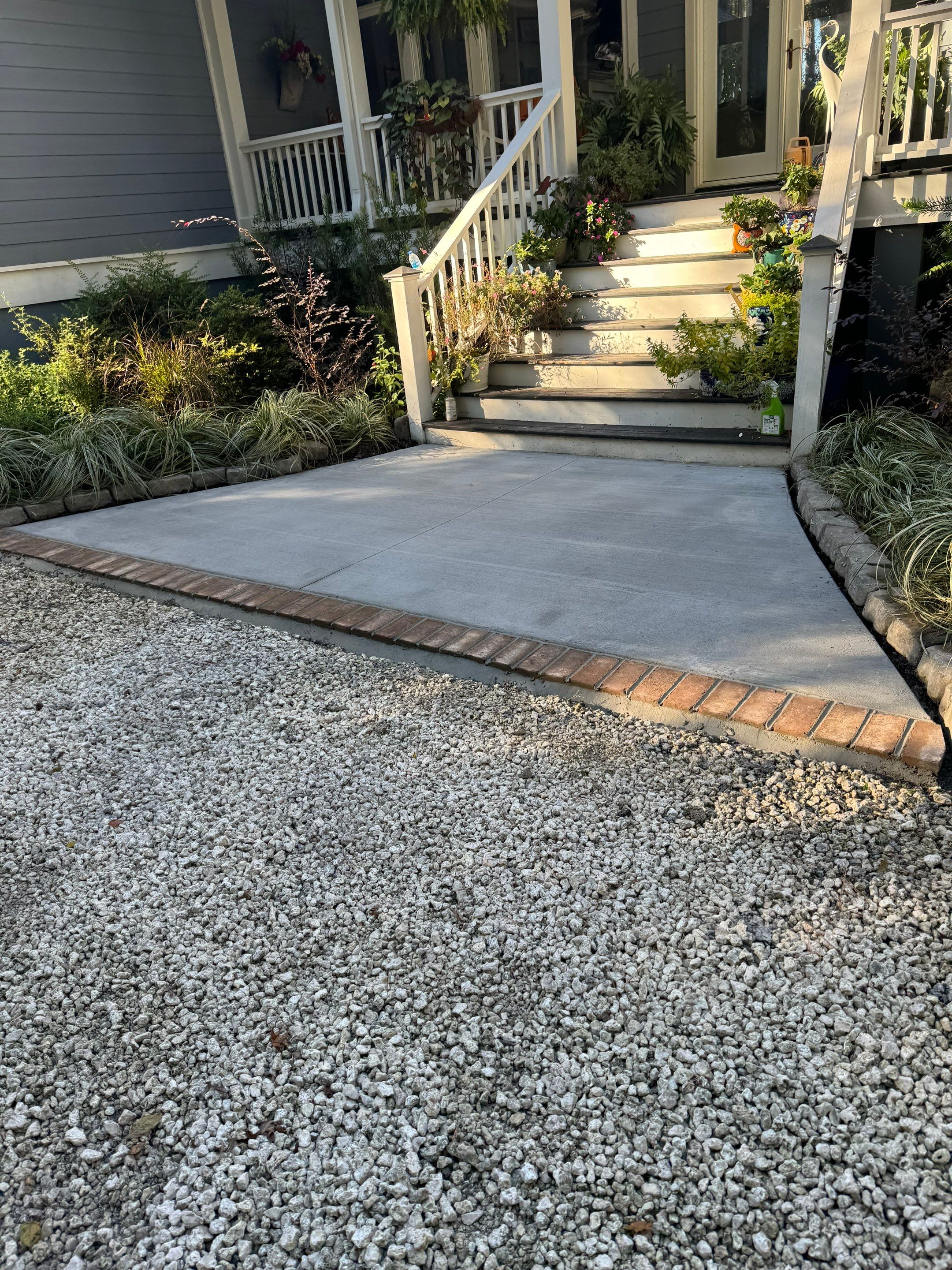 Concrete Driveway and Patio Installation With Decorative Brick Borders by Lowcountry Scapes, LLC