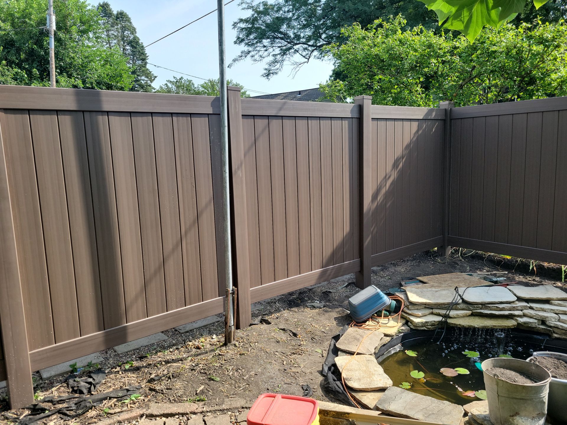 Walnut Vinyl Privacy Fence Installation in Waterloo by Perfect Picket Fence and Stain