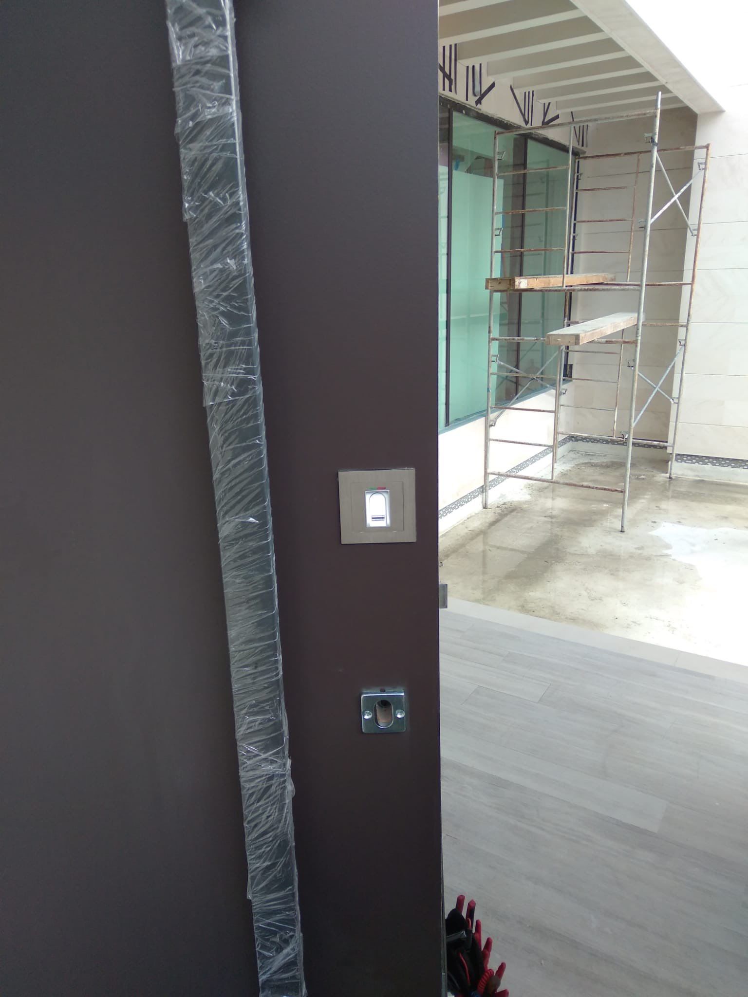 Custom Material Pivot Door installation by Impact Precious Wood Inc.