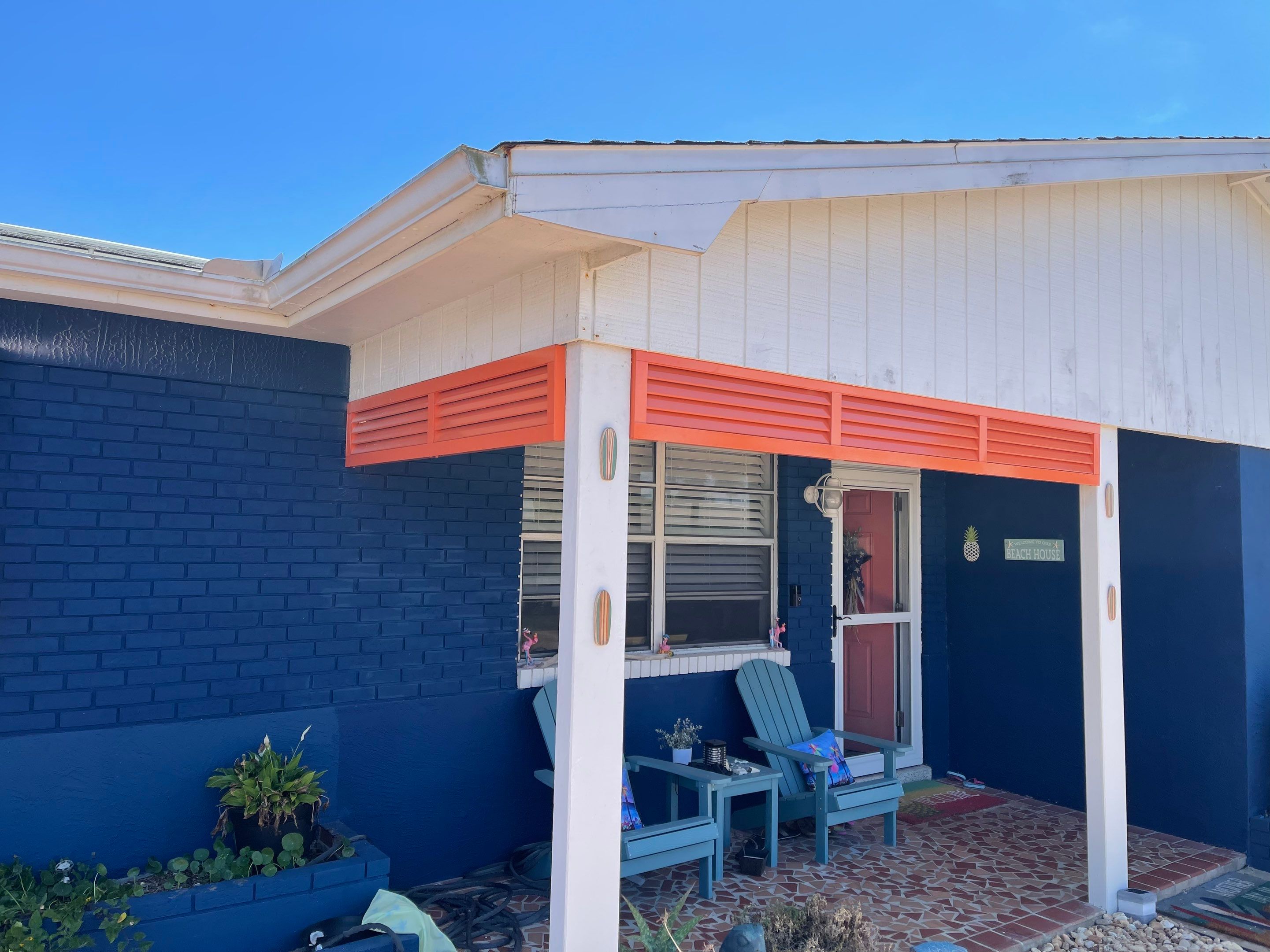 White & Coral Bahama Shutters by Smart Guard Shutters