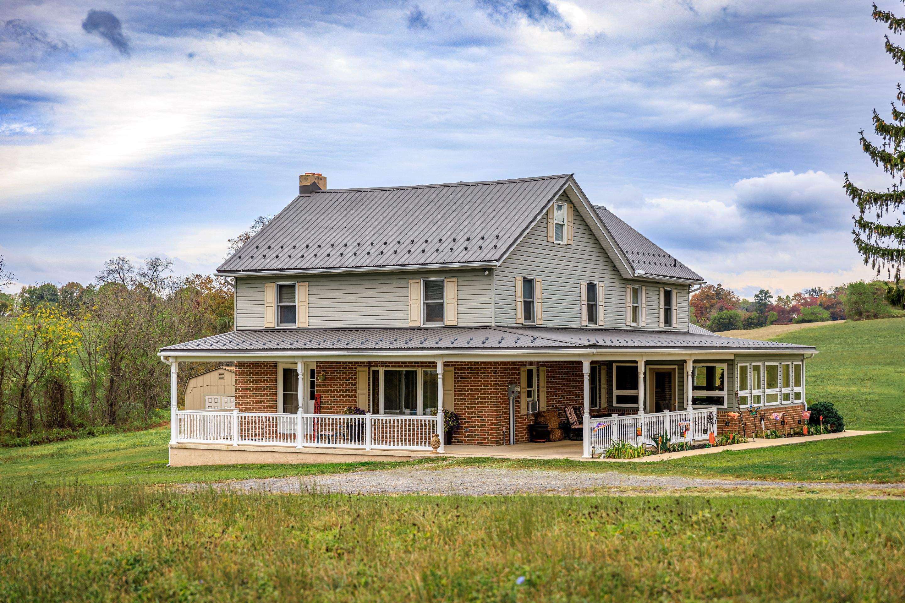 Classic Farmhouse With Textured Charcoal Metal Roof by Esh Builders