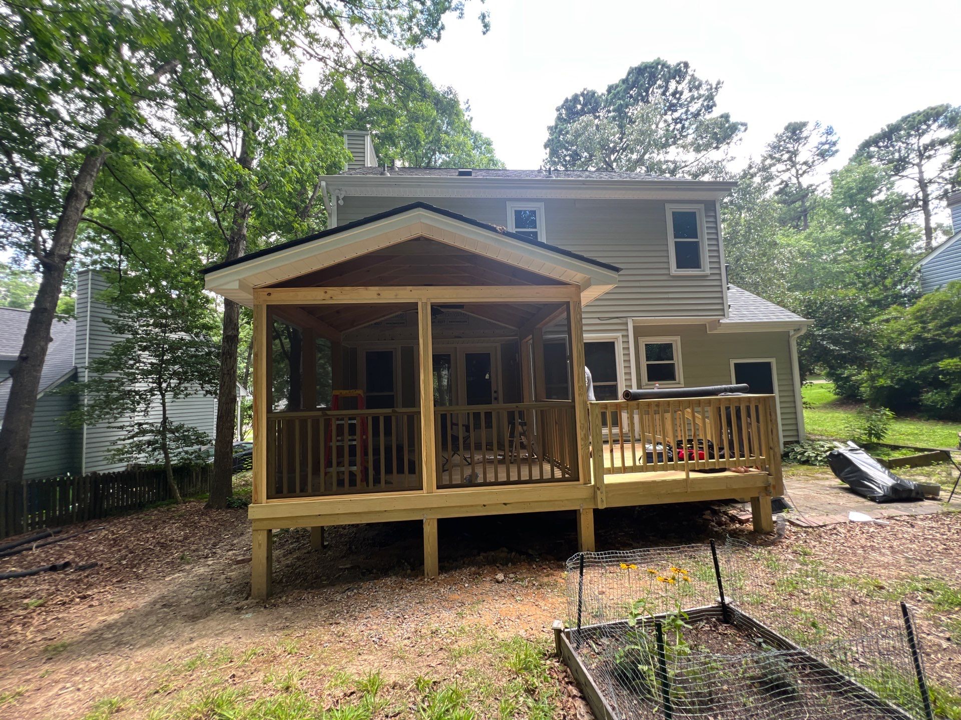 Custom Screen Porch Addition with Gabled Roof and Open Deck by The Remodeling Company