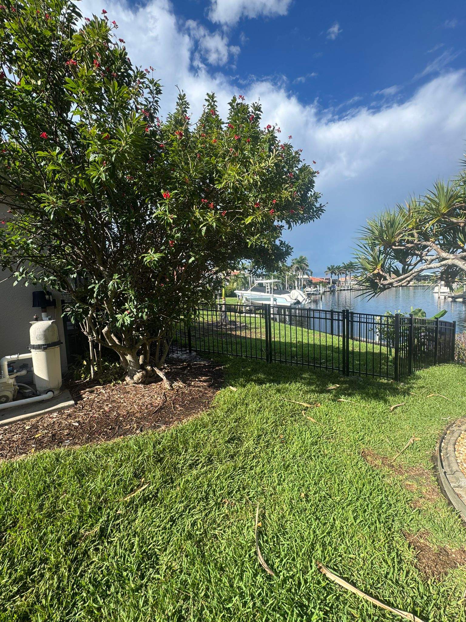 Black Aluminum Fence Installation Along Punta Gorda Canal by True Fence LLC