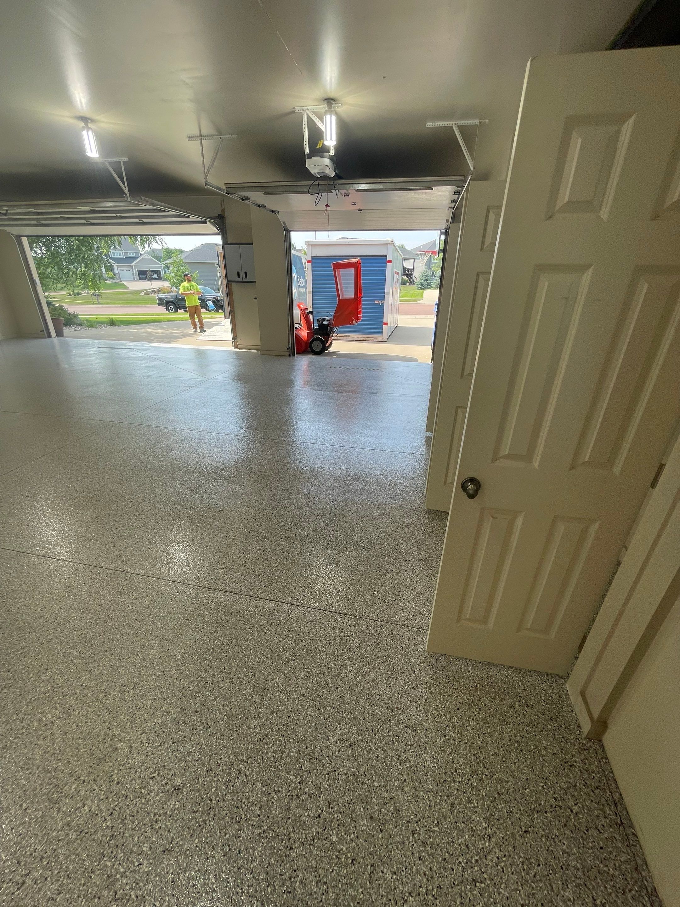 Coyote Flake Garage Floor Coating in Sioux Falls with Trench Drain by Select Painting, Coatings & Garage Cabinets