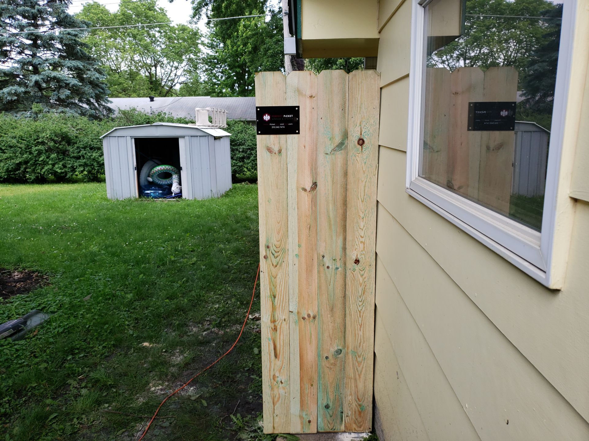 Custom Wood Privacy Fence Installation for Charles City Backyard by Perfect Picket Fence and Stain