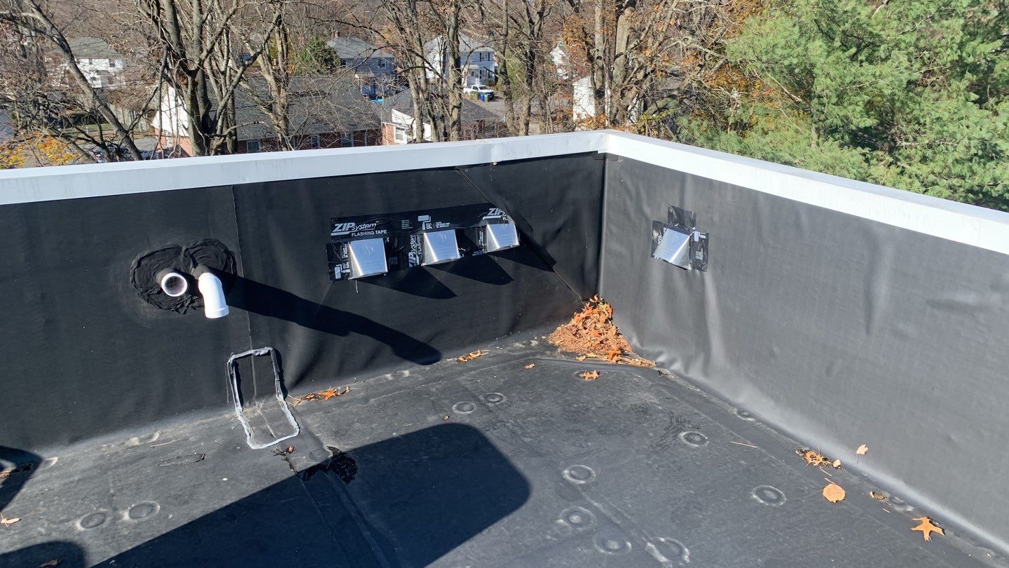 Commercial Roofing Installation using EPDM with white gutters by A Plus Exterior