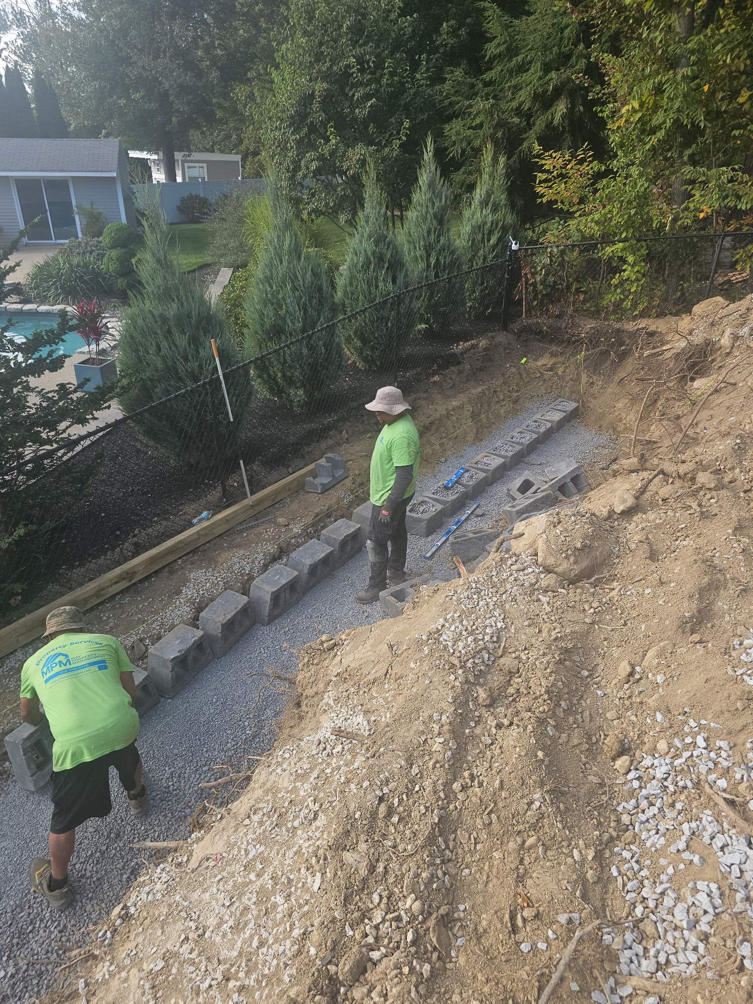 Retaining Wall to Level Backyard  by May Property Management 