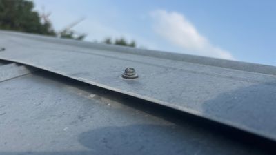 Close up of a metal roof panel seam.