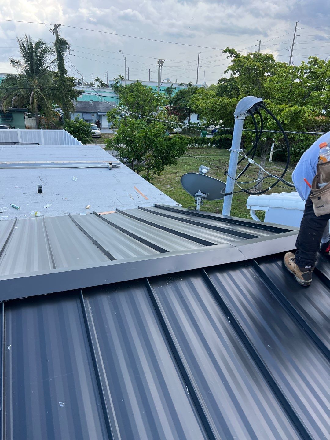 Standing Seam Metal & Flat Re-Roof using 1.5" Nail Strip 24ga Black Matte Kynar Coated Standing Seam Metal Panels by Morton Roofing, Inc.