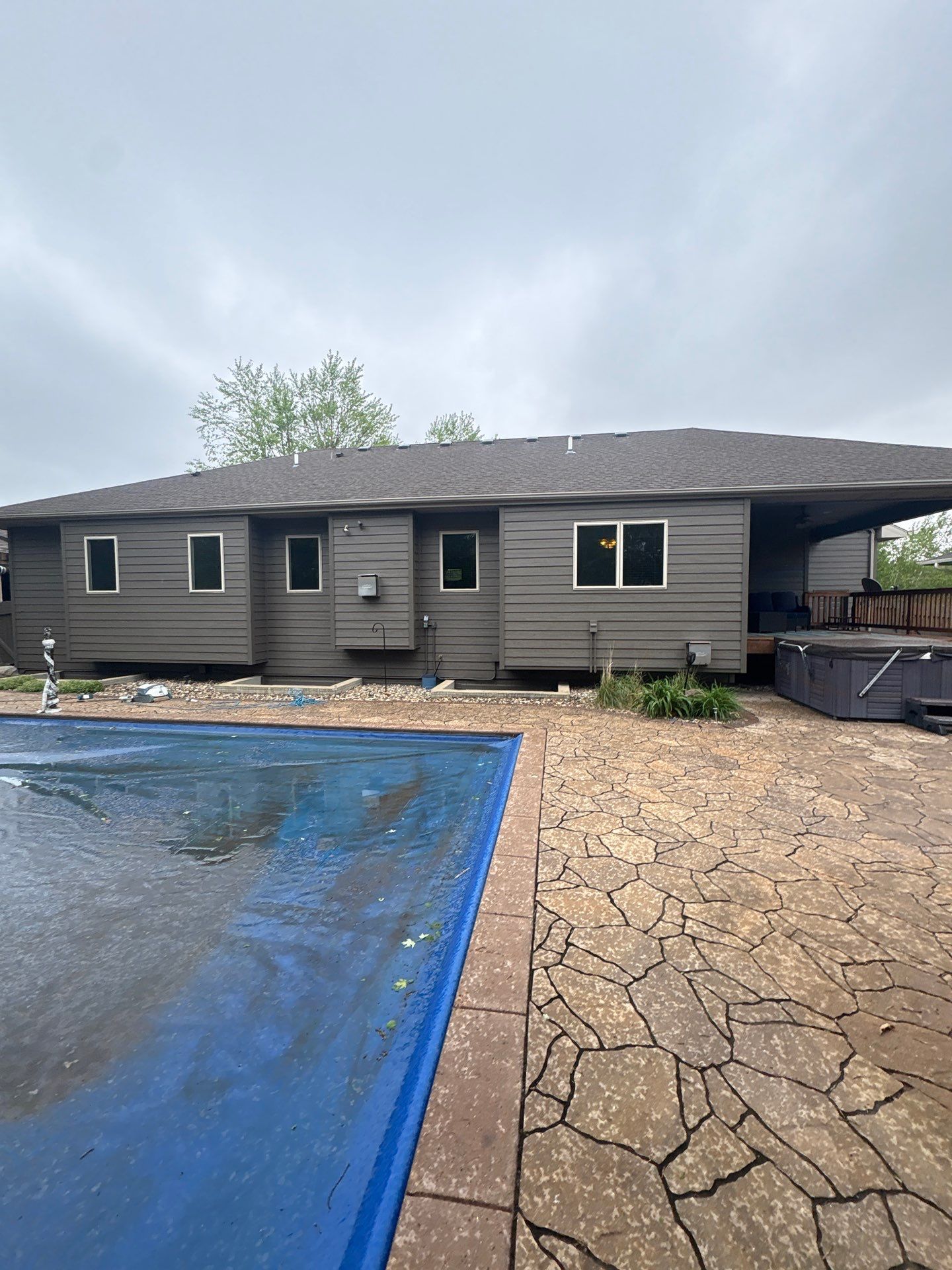 Sioux Falls Residential Exterior Update and Flagstone Pool Deck by Select Painting, Coatings & Garage Cabinets