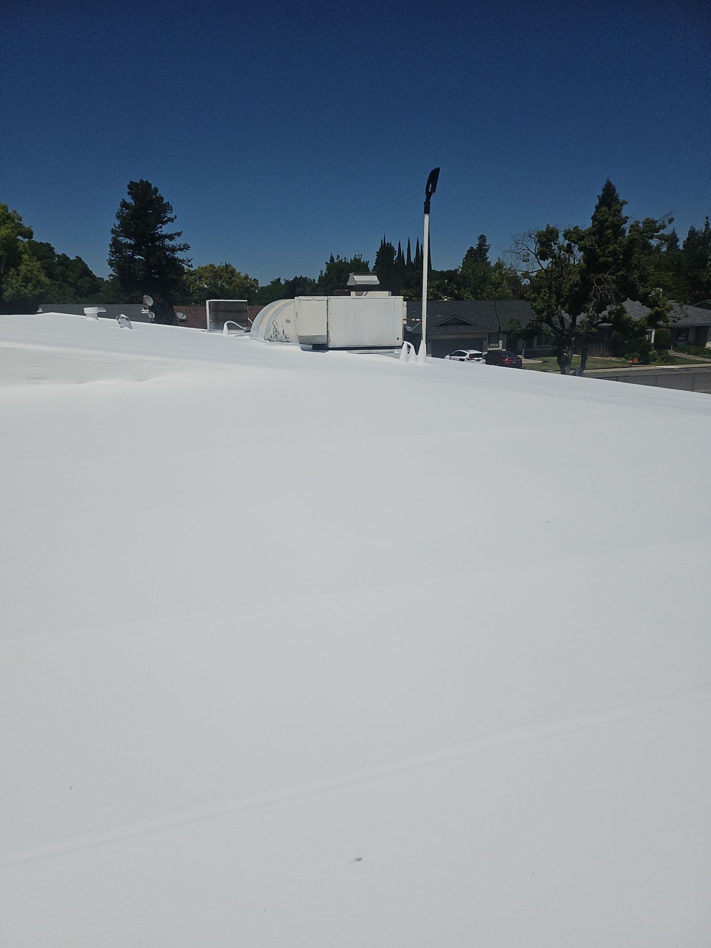 Single-ply restoration system using Benchmark/PUMA XL coatings over TPO single-ply roofing by Straight Edge Roofing Inc