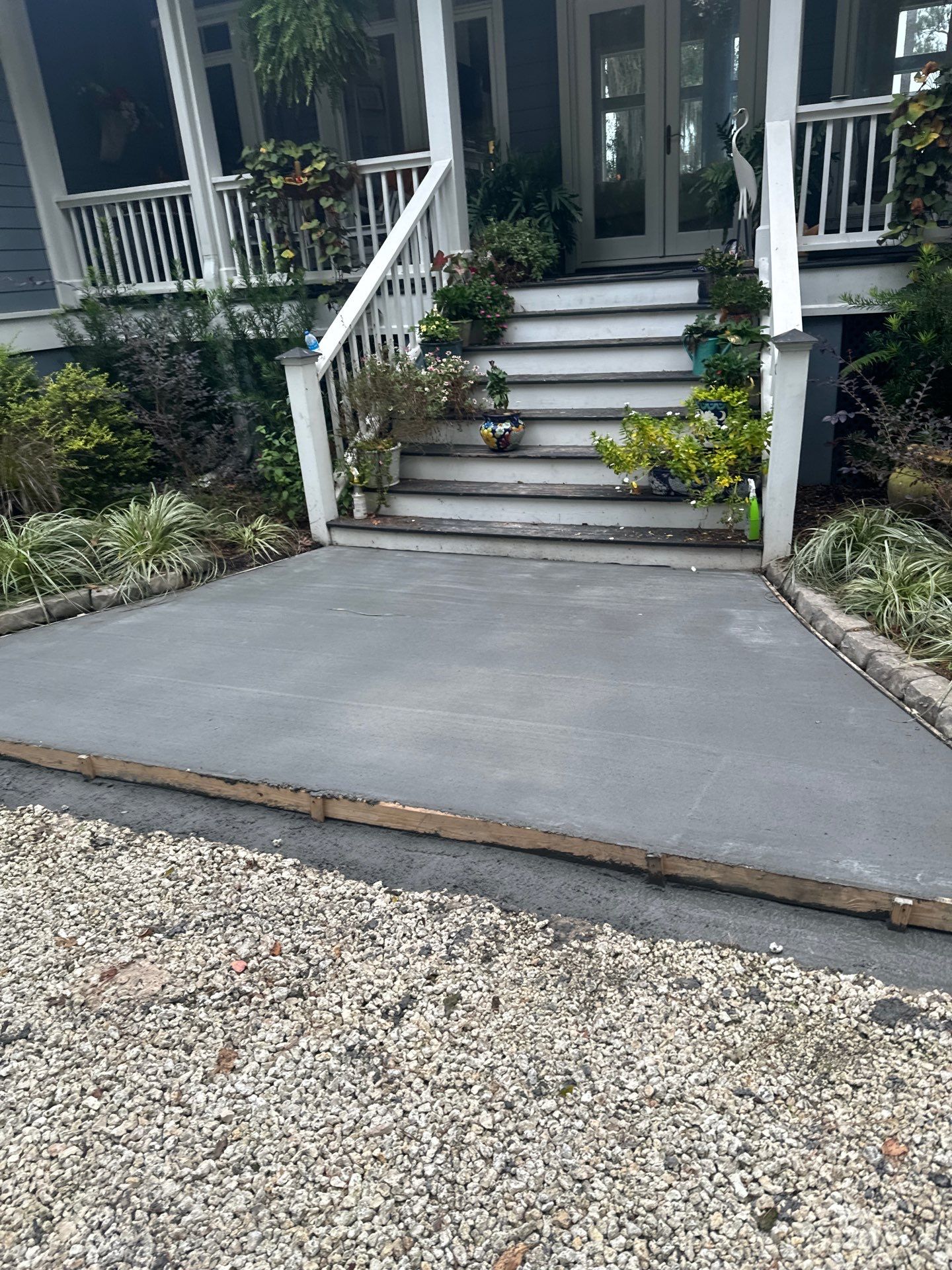 Concrete Driveway and Patio Installation With Decorative Brick Borders by Lowcountry Scapes, LLC