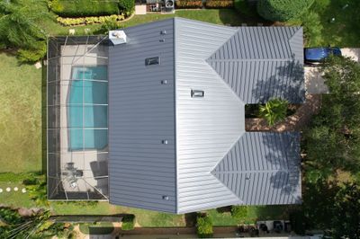 Standing Seam Metal Charcoal Grey Roof Replacement and Skylight Installation in Jupiter