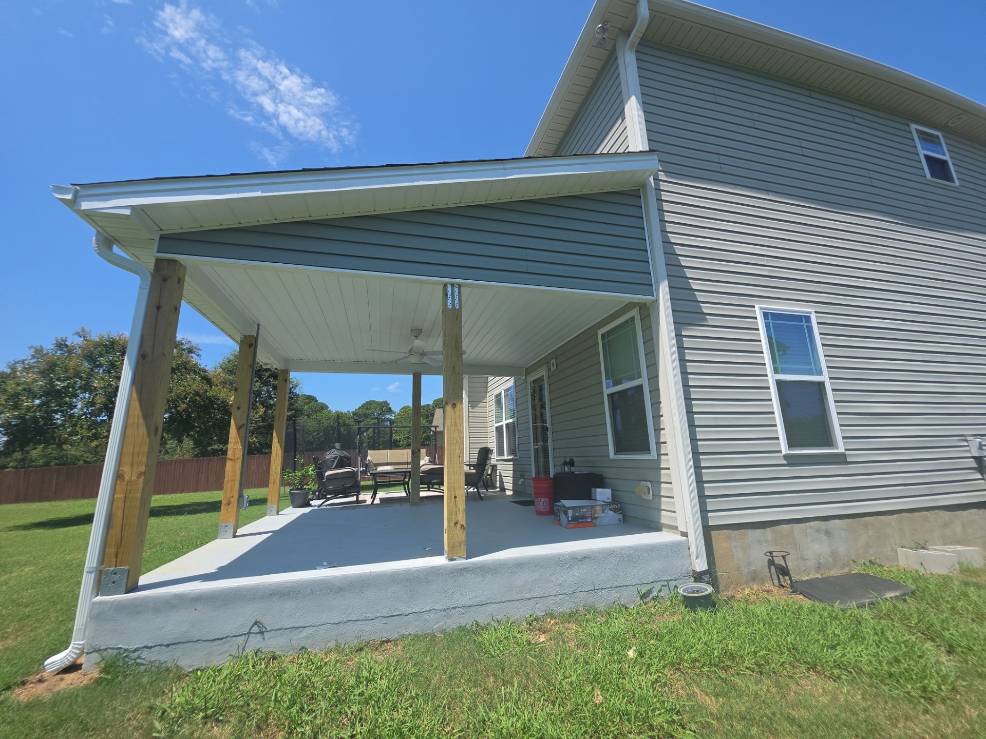 Covered Patio Roof Construction with Architectural Shingles in Garner by The Remodeling Company