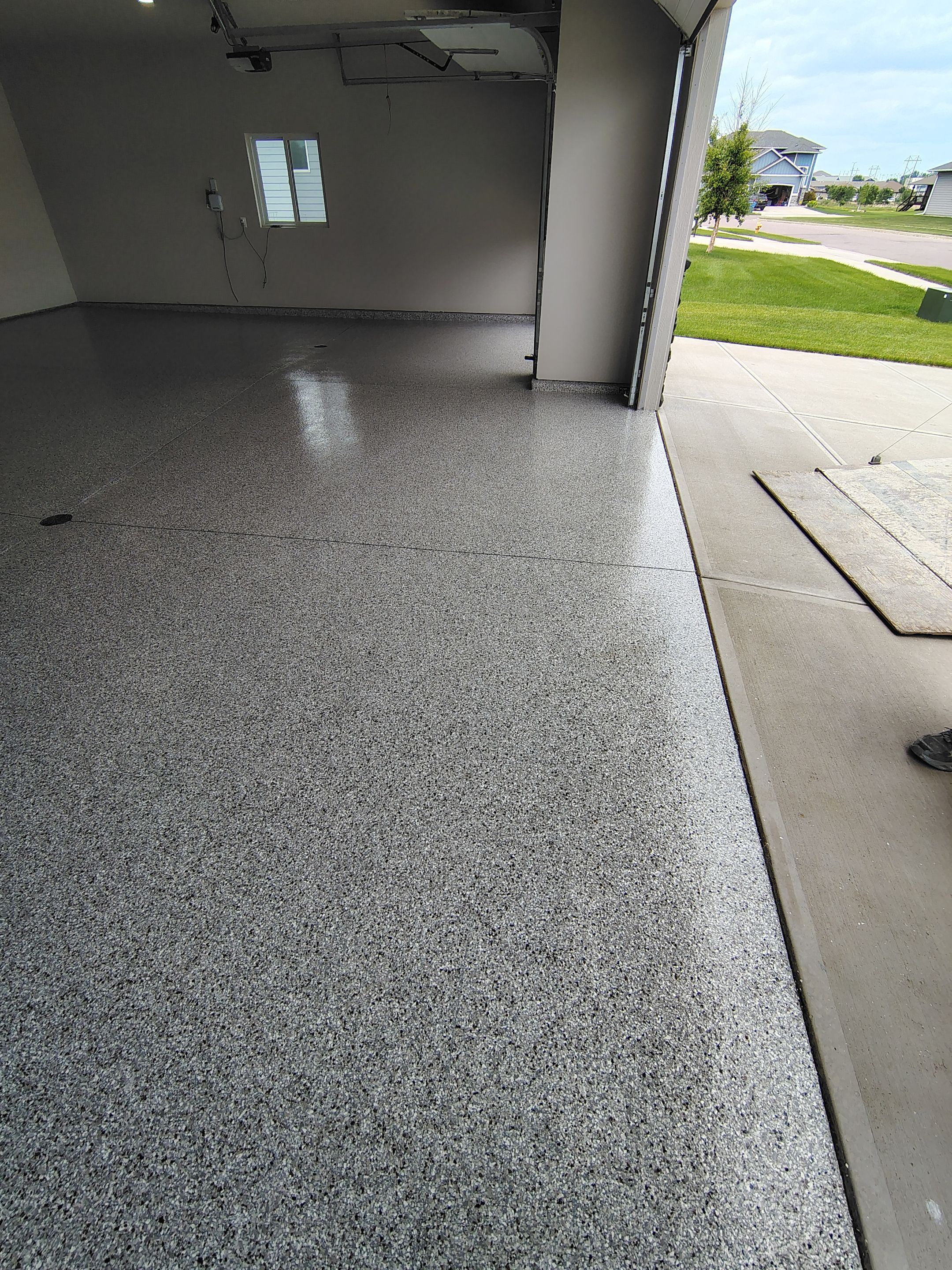 Grey Speckled Epoxy Garage Floor Coating in Sioux Falls by Select Painting, Coatings & Garage Cabinets