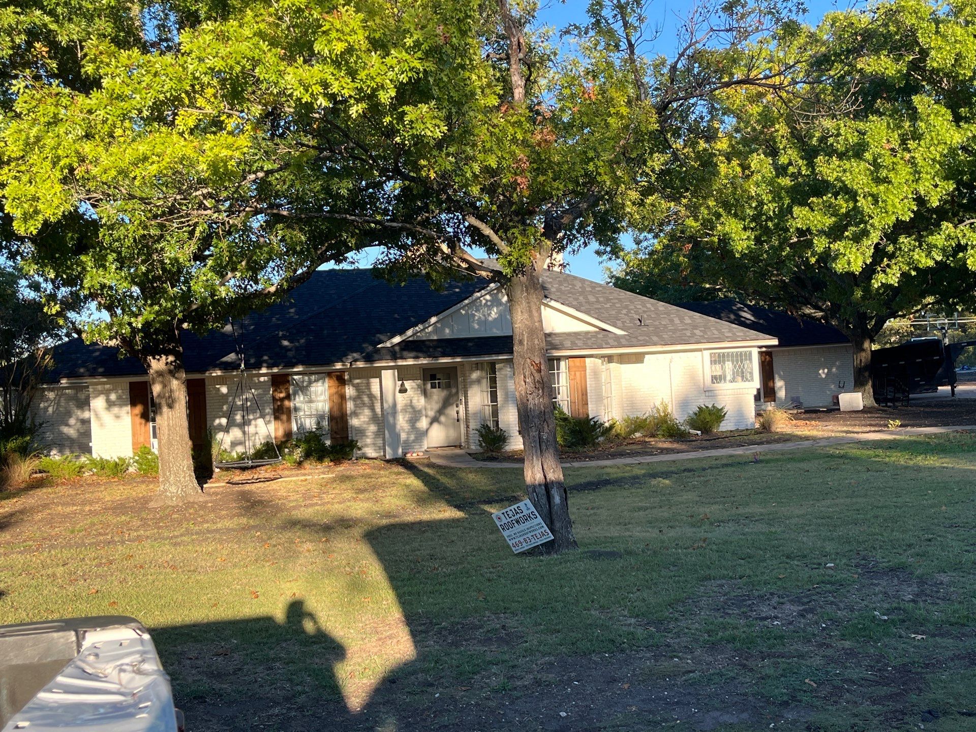 White brick with IKO Granite Black by Tejas Roofworks + Restoration