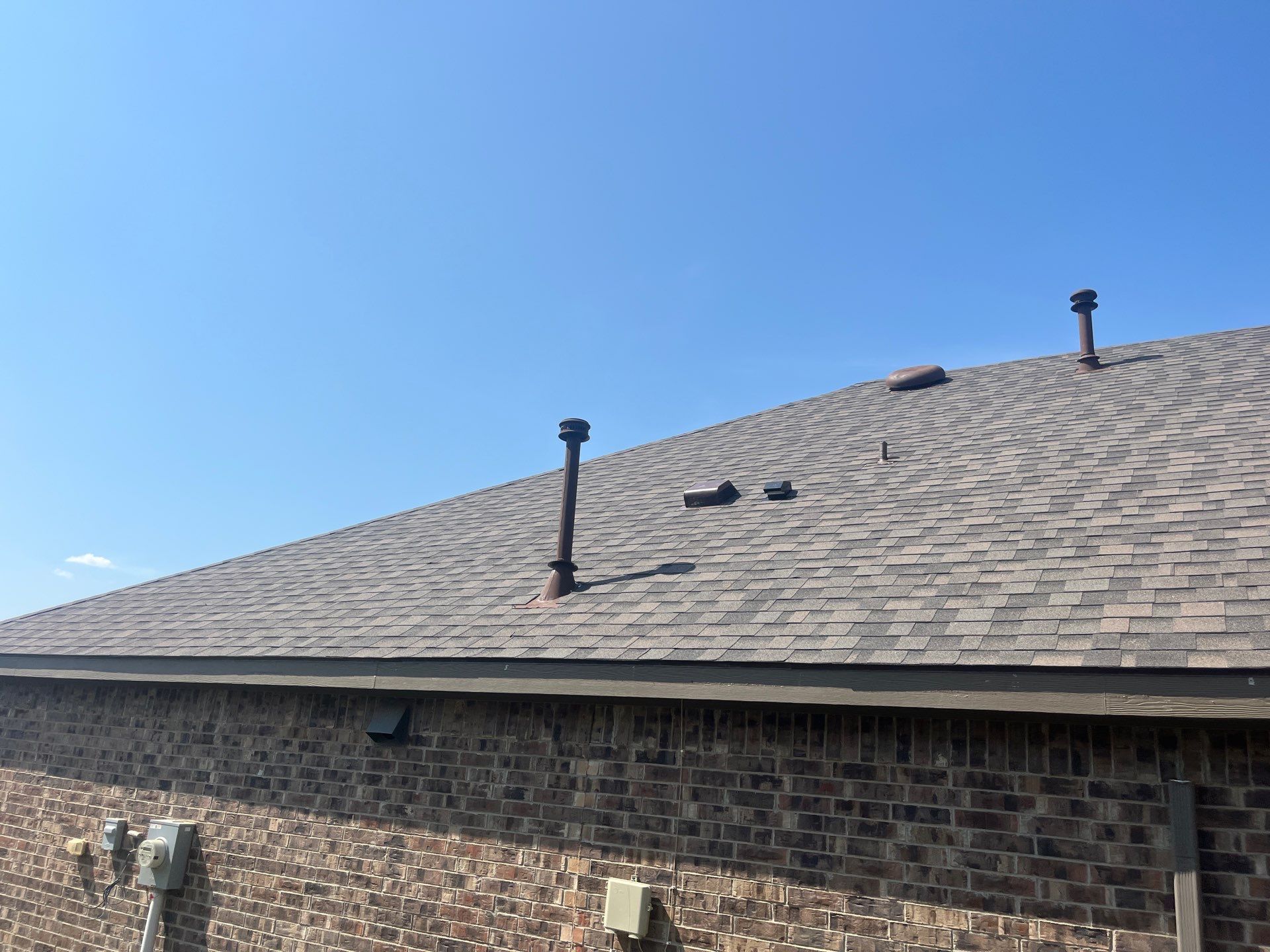 Medium brown brick with IKO Driftshake by Tejas Roofworks + Restoration
