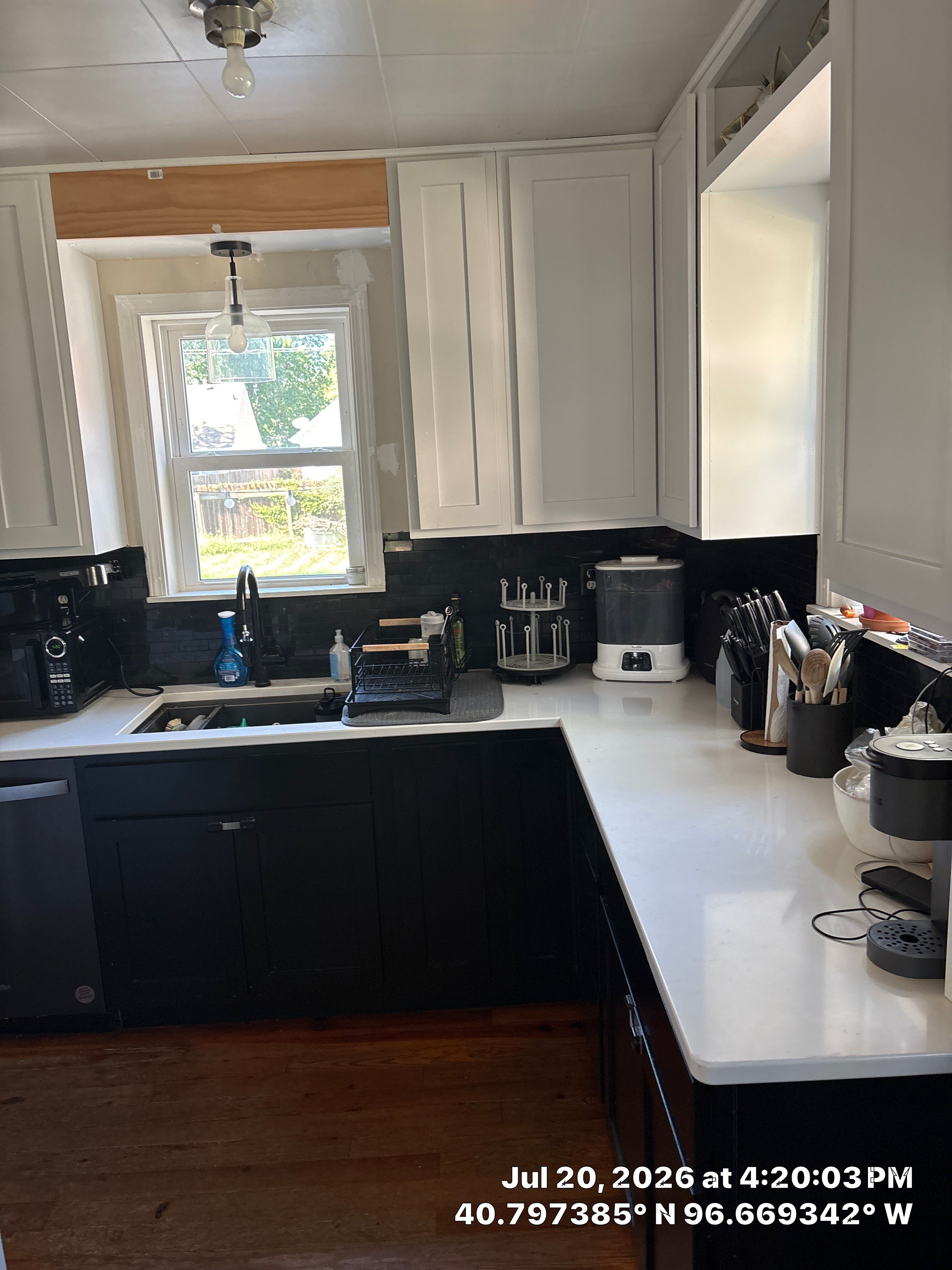 Kitchen Remodel in Lincoln Nebraska Featuring Two-Tone Cabinetry and Black Backsplash by CompanyCam Sales Demo