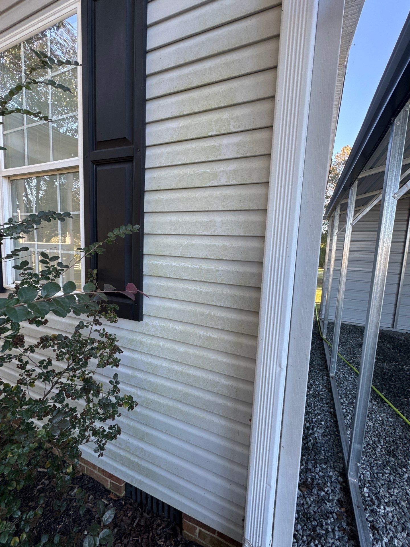 the service shown is cleaning a house exterior siding to remove dirt and grime from the surface