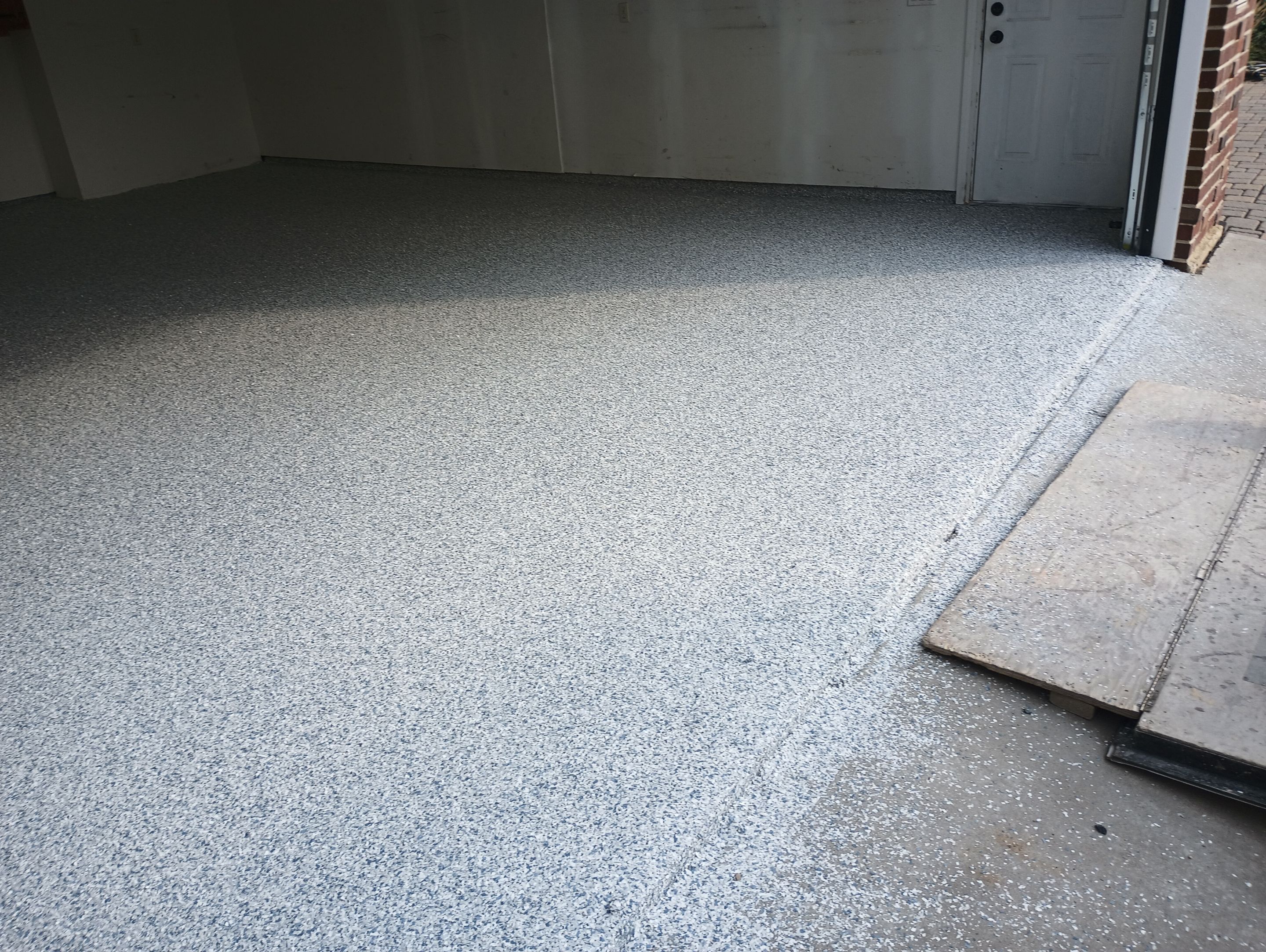 Garage Concrete Coating Installation in Sioux Falls Using Tidal Wave Finish by Select Painting, Coatings & Garage Cabinets