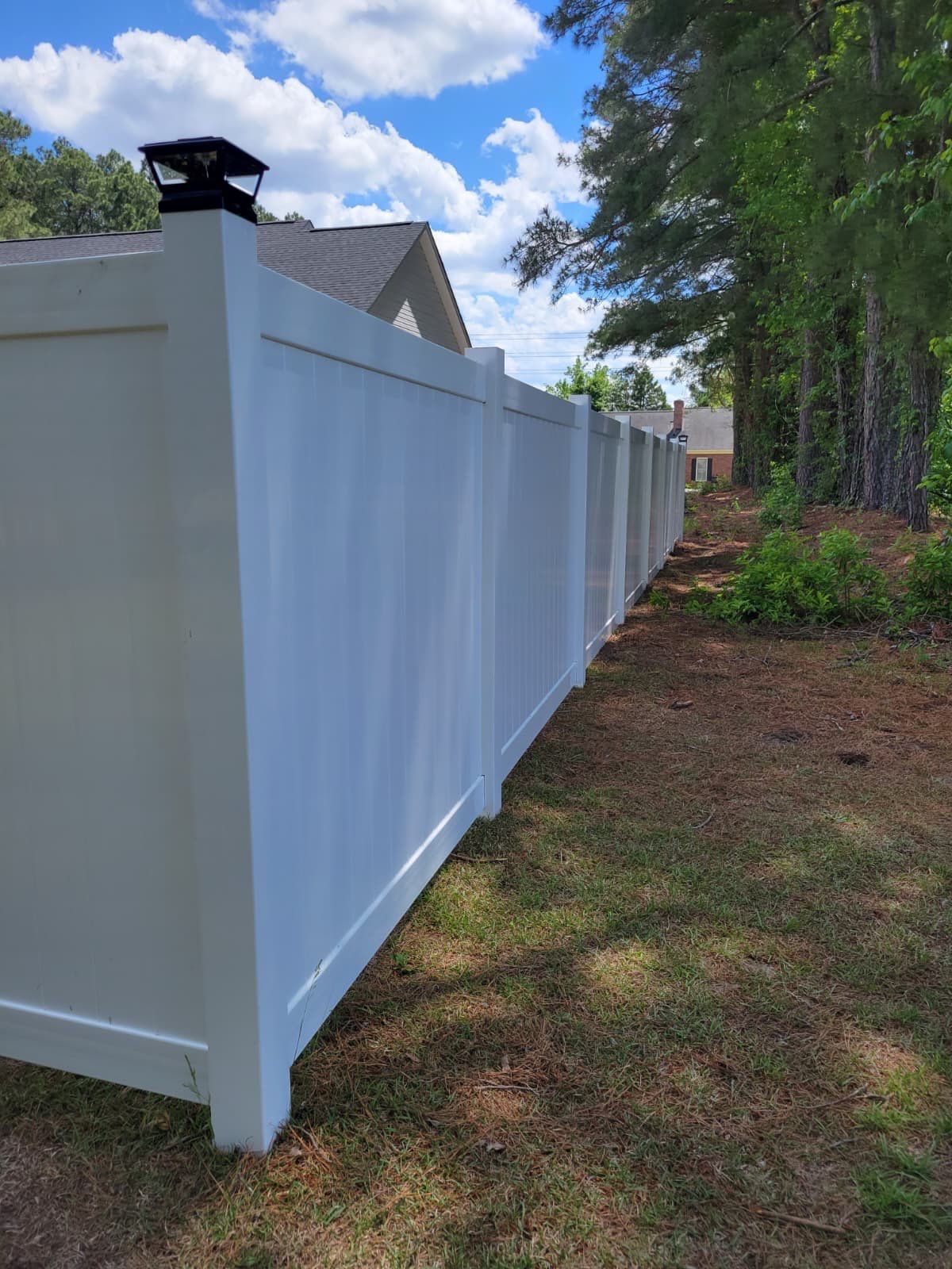 White Vinyl Privacy Fence with Solar Post Caps in Goldsboro by Superior Fence and Rail