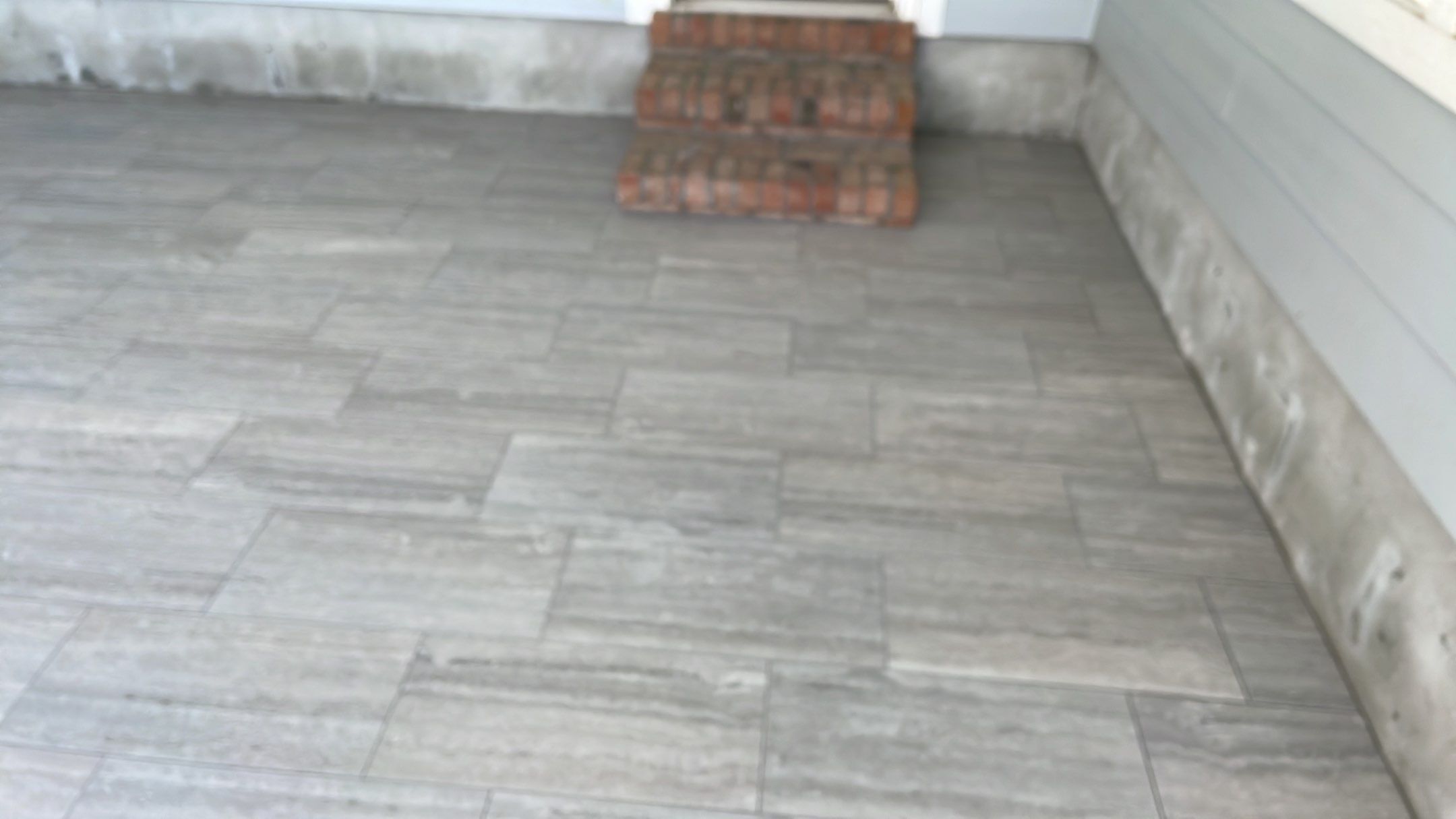 Sunroom using 12x24 tiles by Footprints Floors of Coastal Carolina