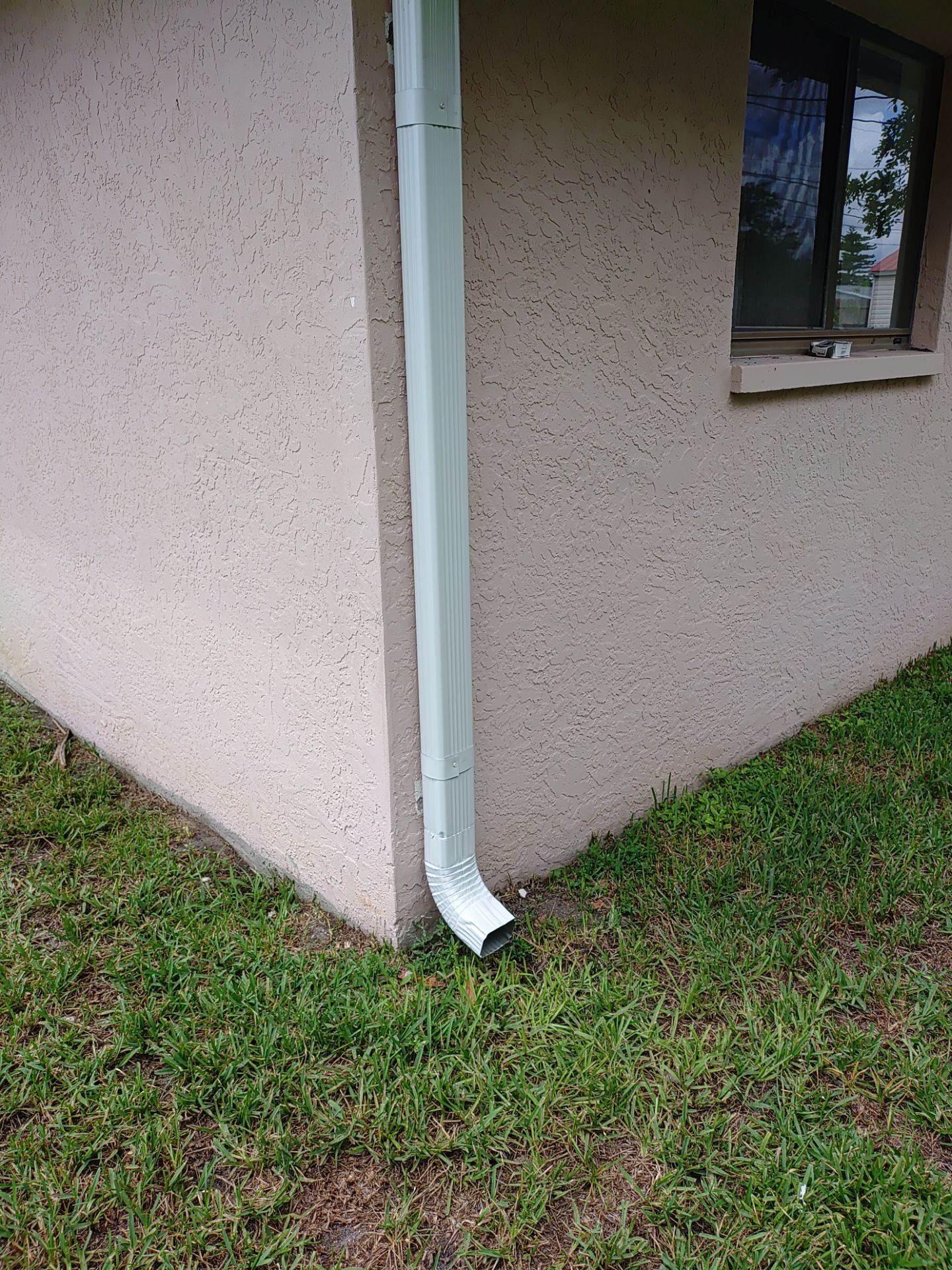 Replace gutter using White Down Spouts in Cape Coral FL by Gutter Professors