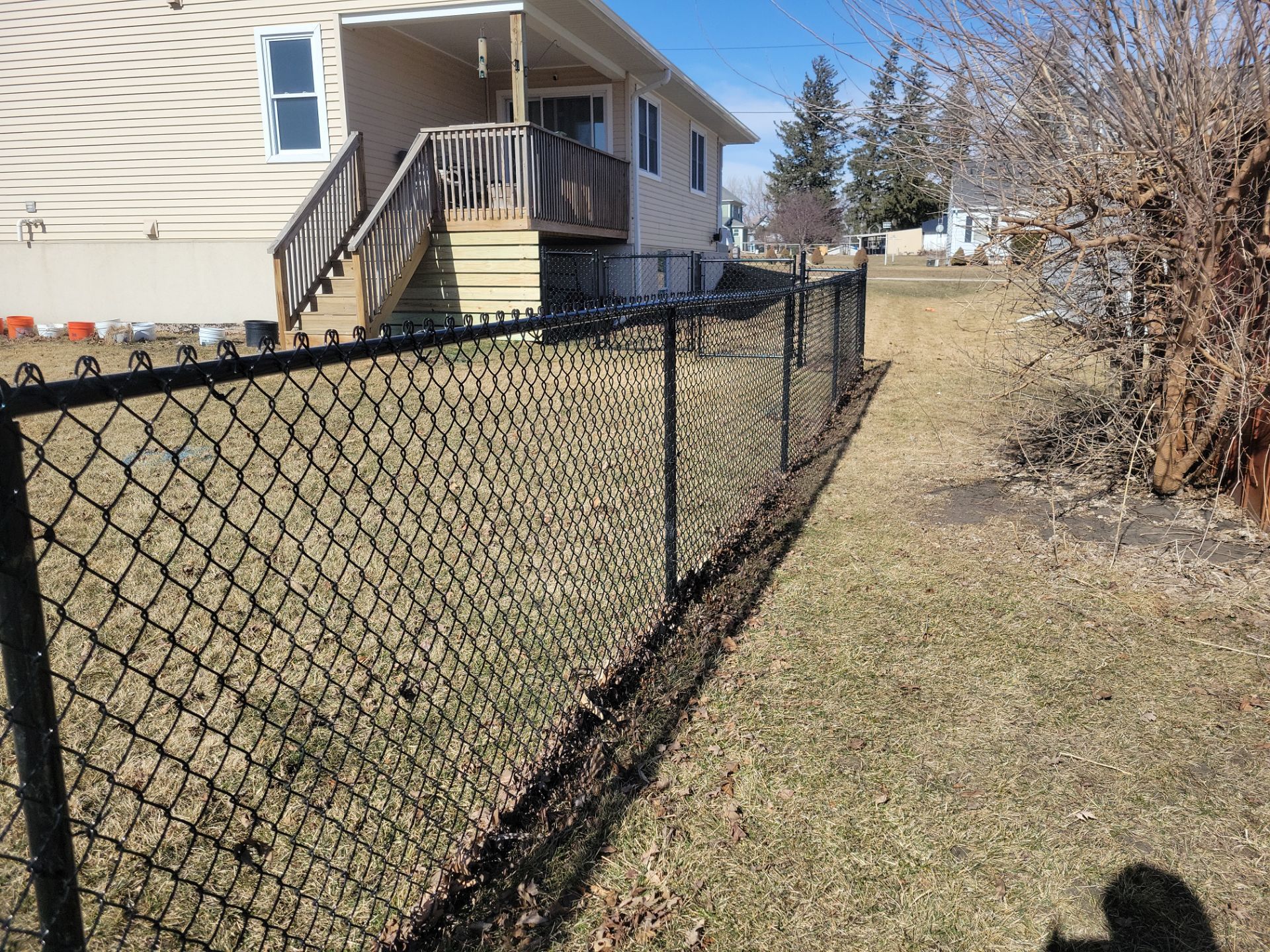 Residential Black Chain Link Fence and Gate Installation in Tripoli by Perfect Picket Fence and Stain
