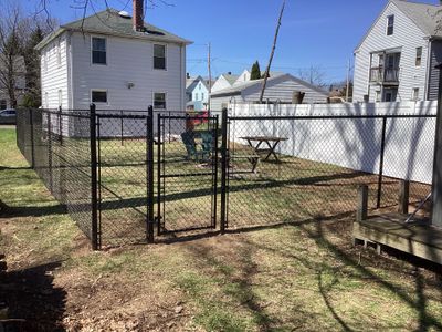 New Black Chain link and White Vinyl privacy fence with matching chain link gate.
