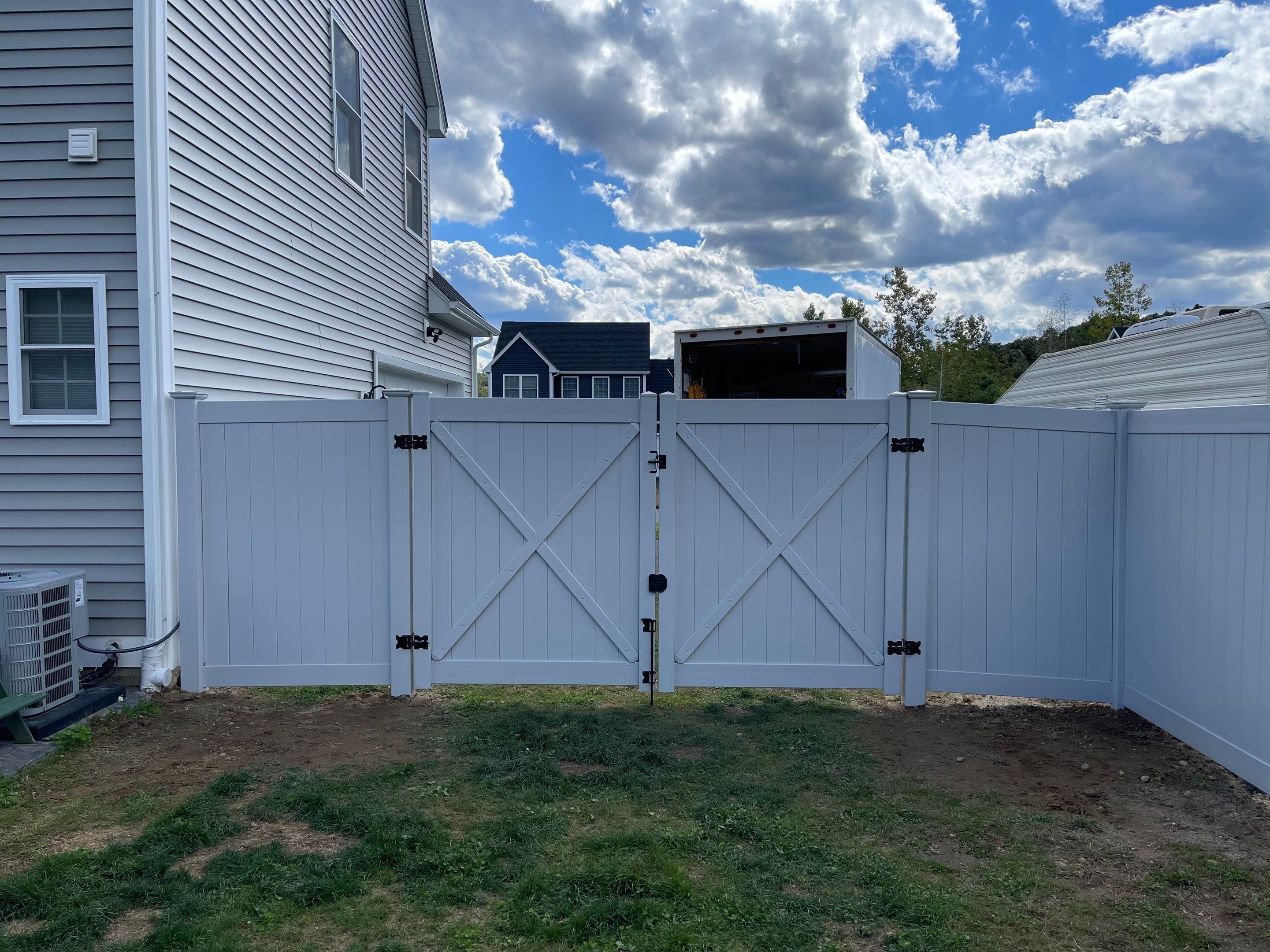New Vinyl privacy fence with matching gates in Classic Gray by DiGiorgi Roofing and Siding Inc