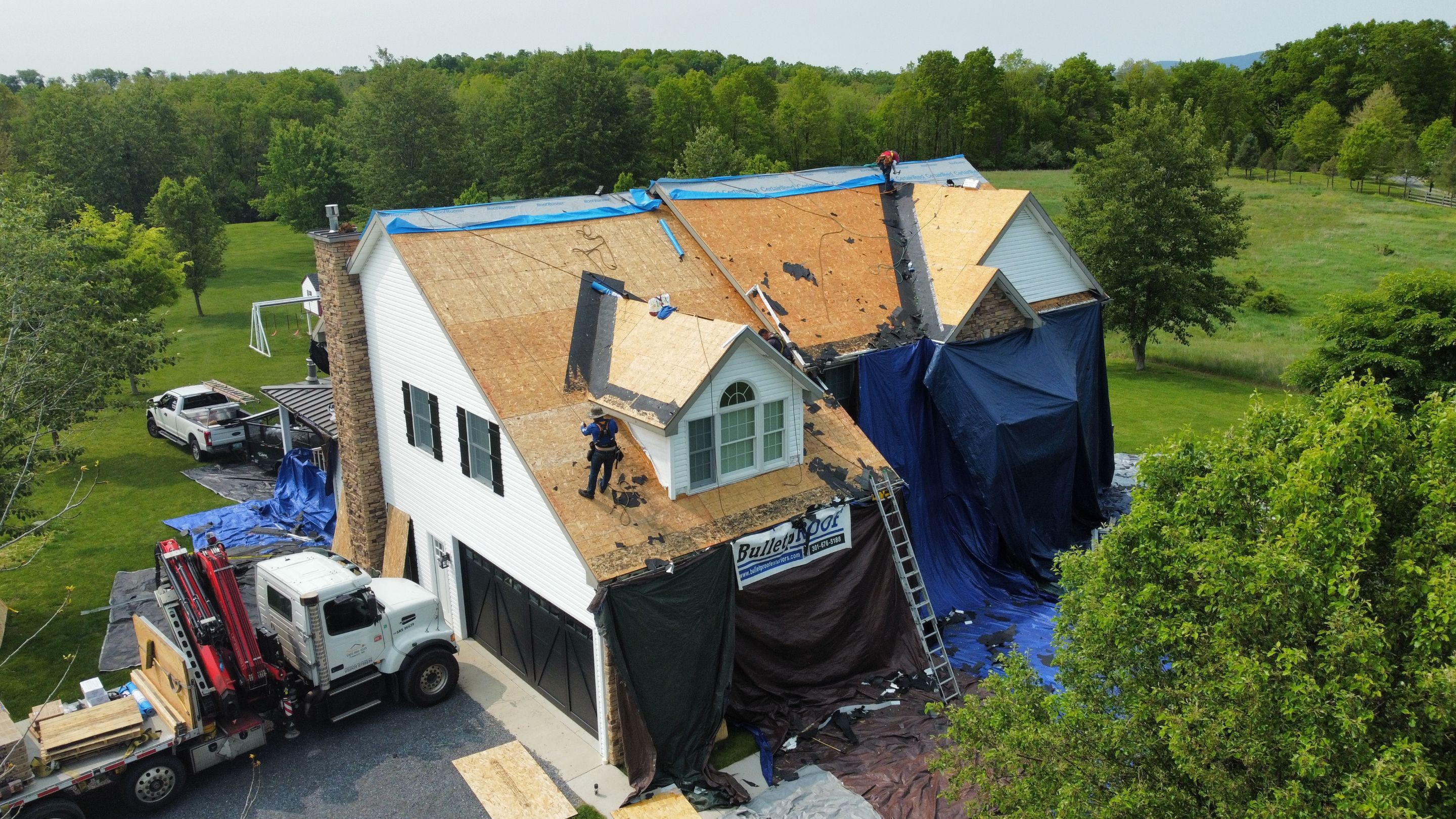 Roof Damage using Certainteed Lifetime Roofing System- Moire Black Landmark Pro shingkes with shadow ridge caps. by BulletpROOF Exteriors