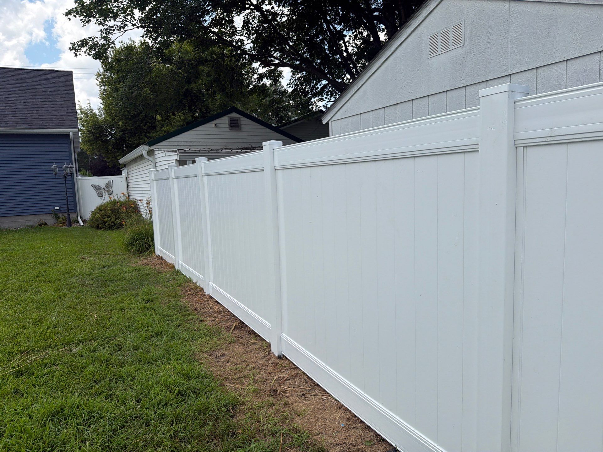 White Vinyl Privacy Fence Installation in Waterloo, Iowa by Perfect Picket Fence and Stain