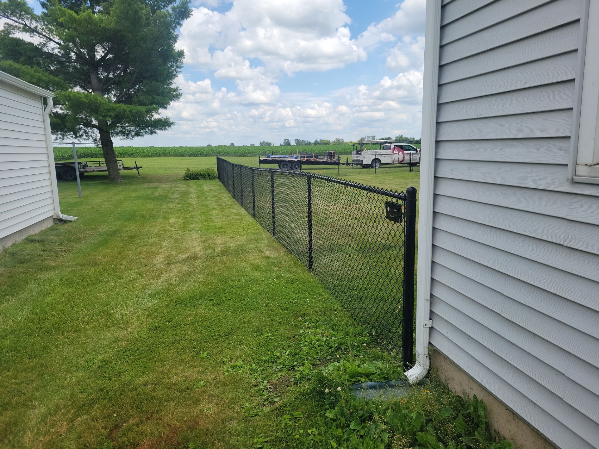 Residential Black Vinyl-Coated Chain Link Fence Installation in Allison by Perfect Picket Fence and Stain