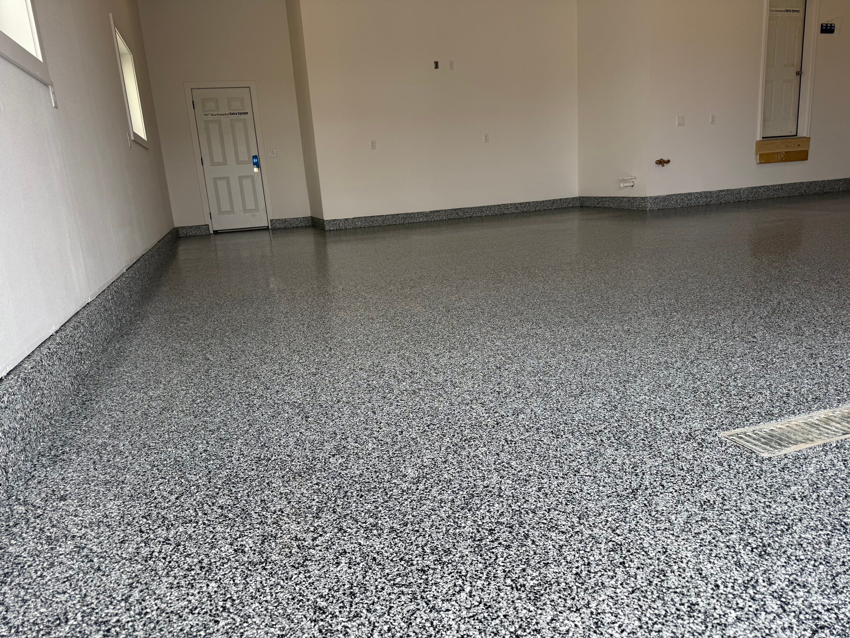 Multi-Car Garage Epoxy Floor Coating and Concrete Finishing in Sioux Falls by Select Painting, Coatings & Garage Cabinets