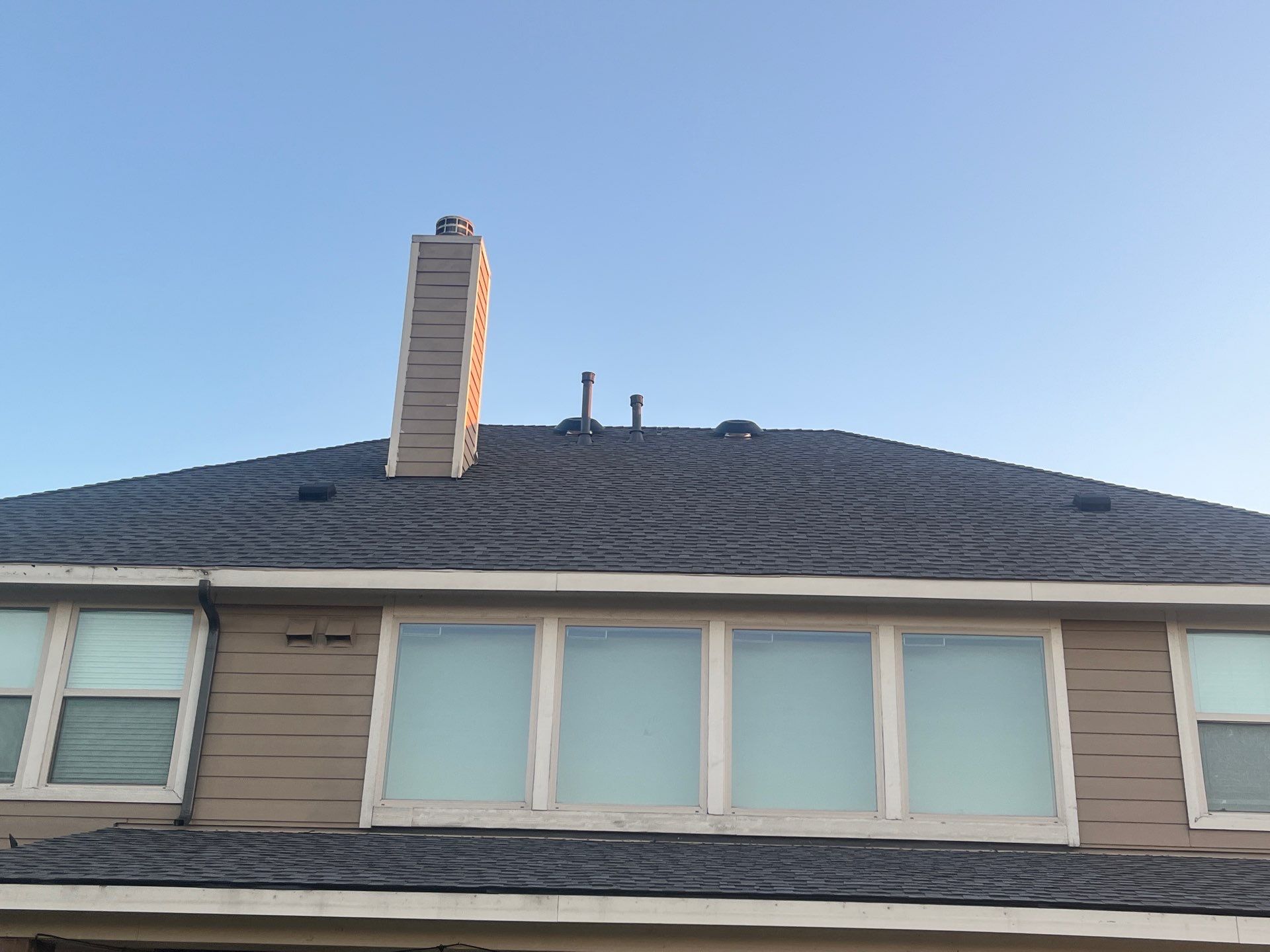 Medium brown brick with GAF Pewter Gray  by Tejas Roofworks + Restoration