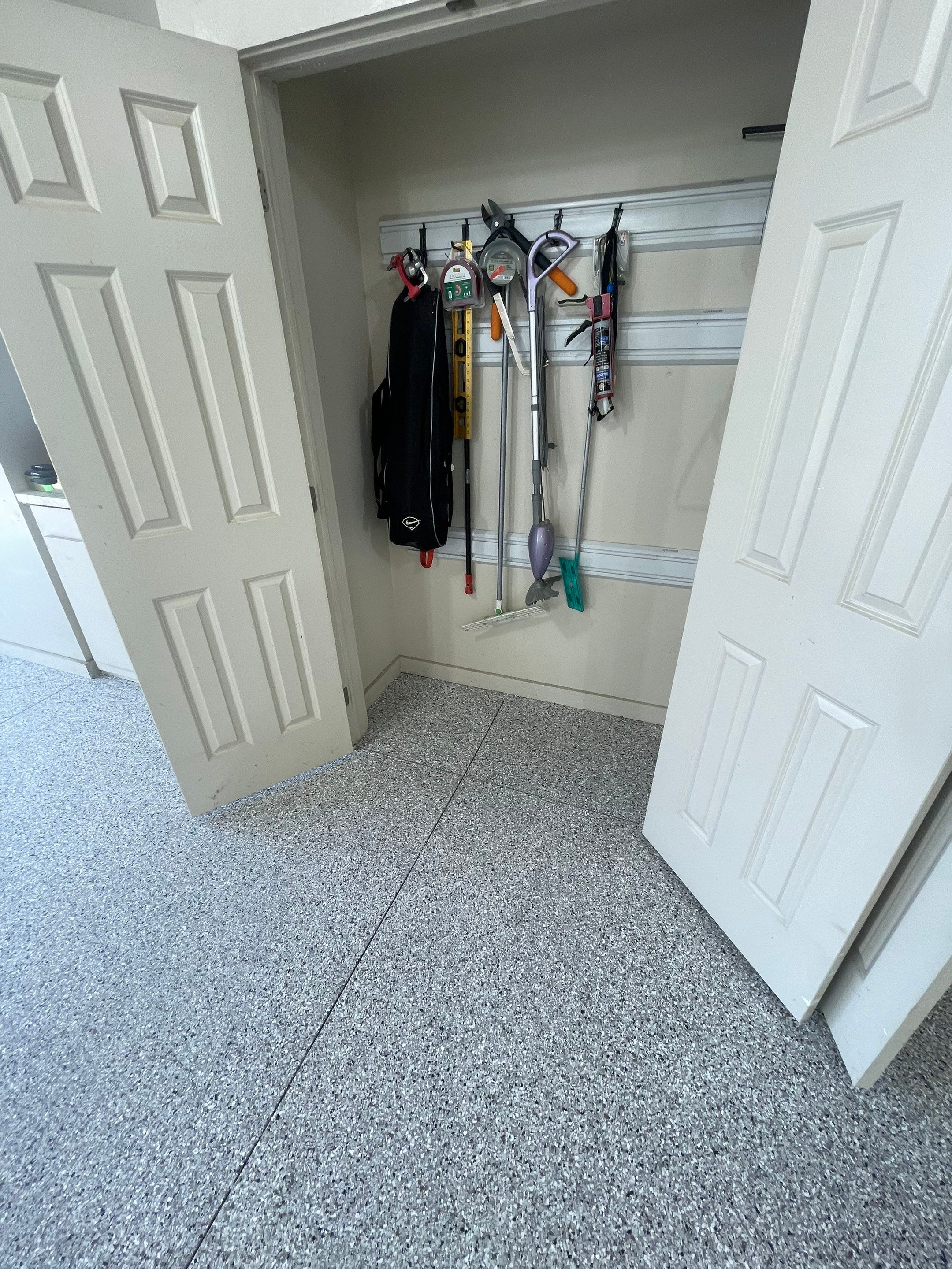 Coyote Flake Garage Floor Coating in Sioux Falls with Trench Drain by Select Painting, Coatings & Garage Cabinets