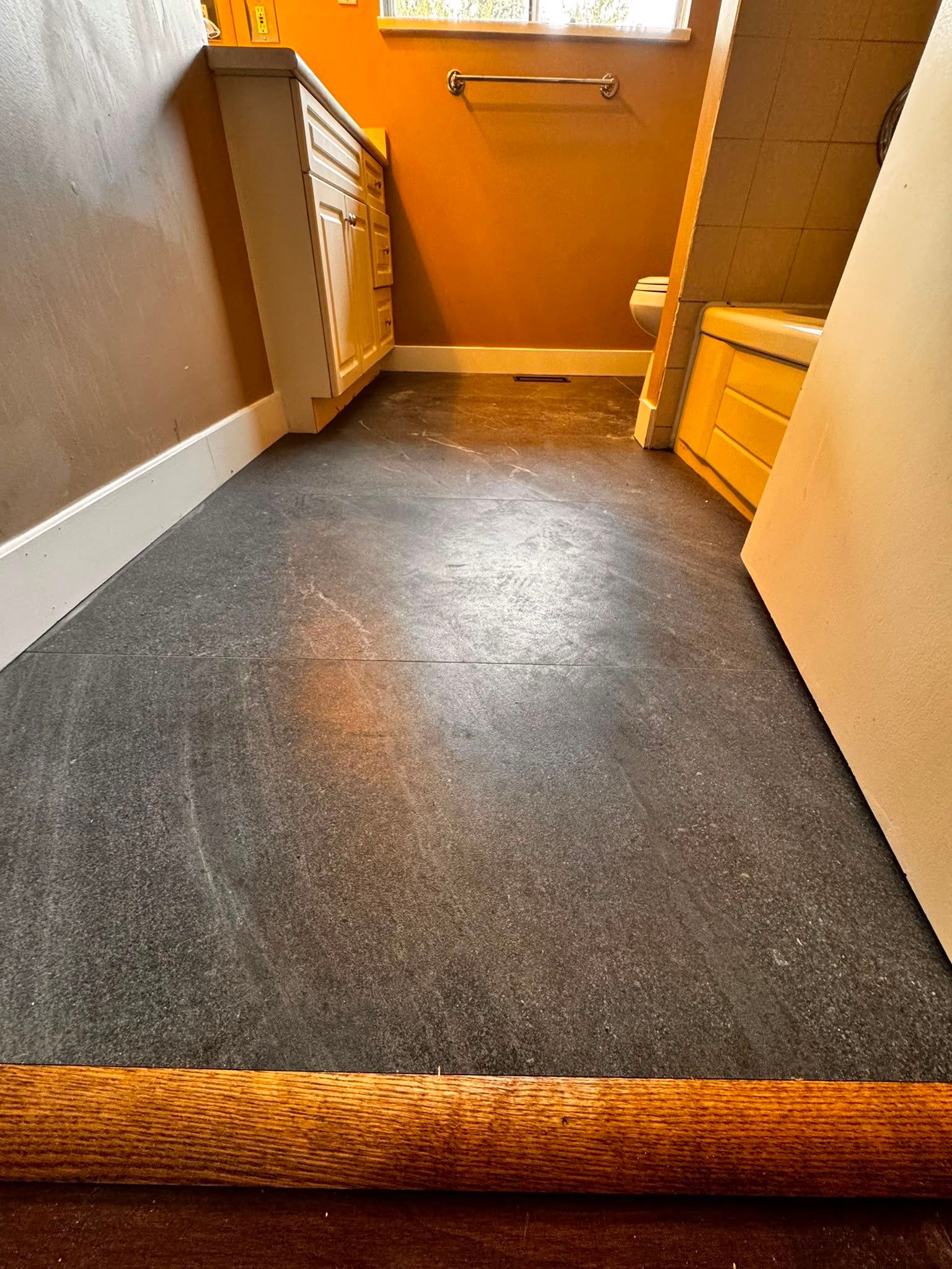 Bathroom Tile Floor Upgrade After Toilet Leak – West Vancouver Rental Property by YVR Construction Group