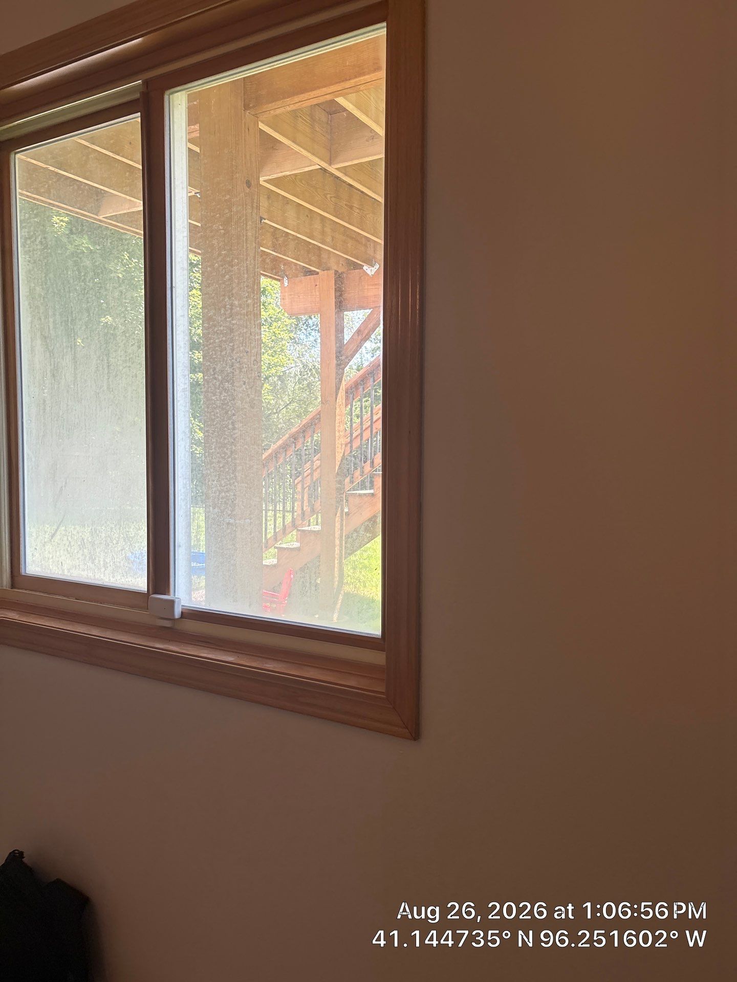 Residential Sliding Window Installation With Natural Wood Trim by CompanyCam Sales Demo