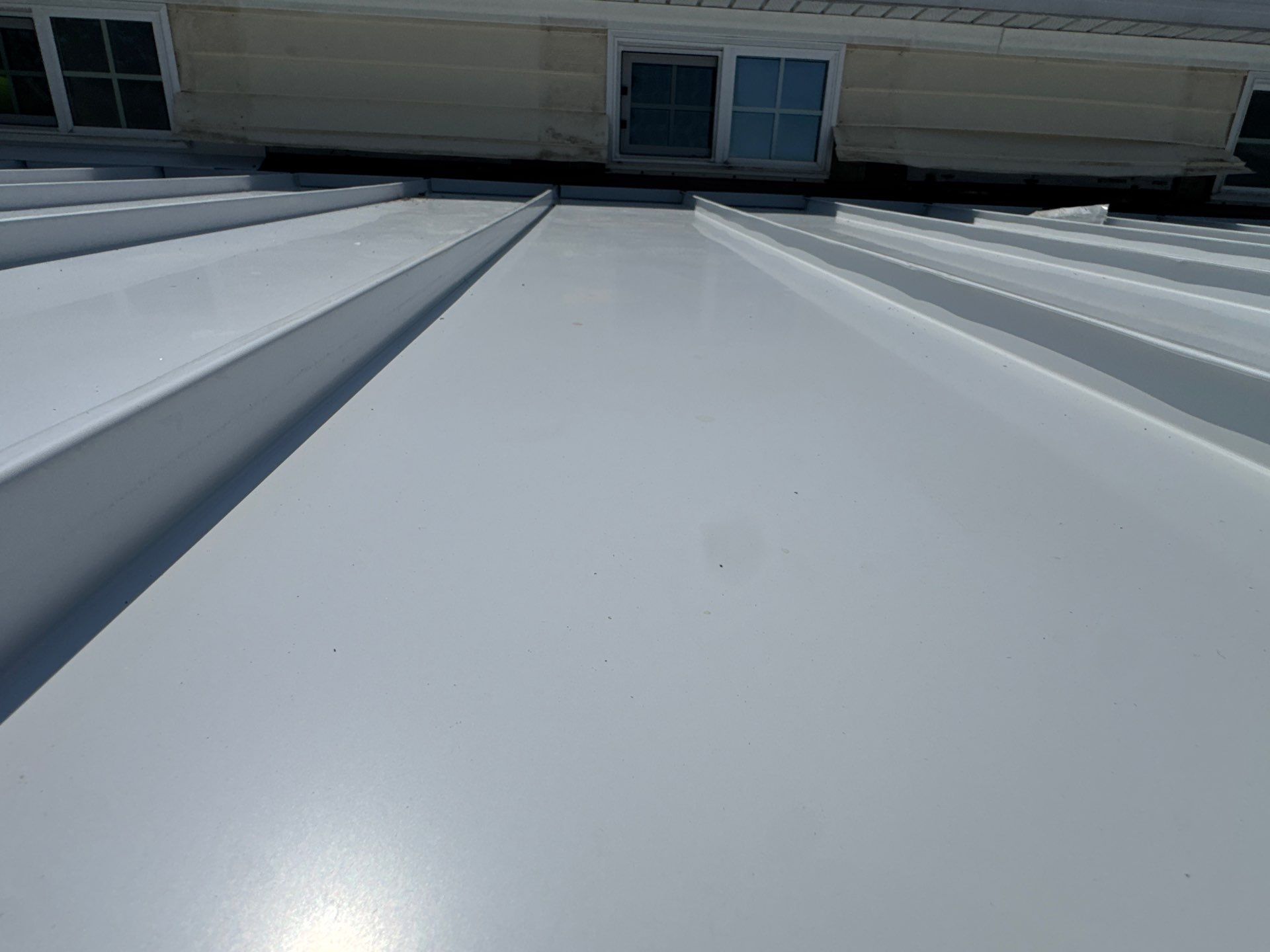 White Standing Seam Metal Roof Installation in Wake, VA by Cade Construction