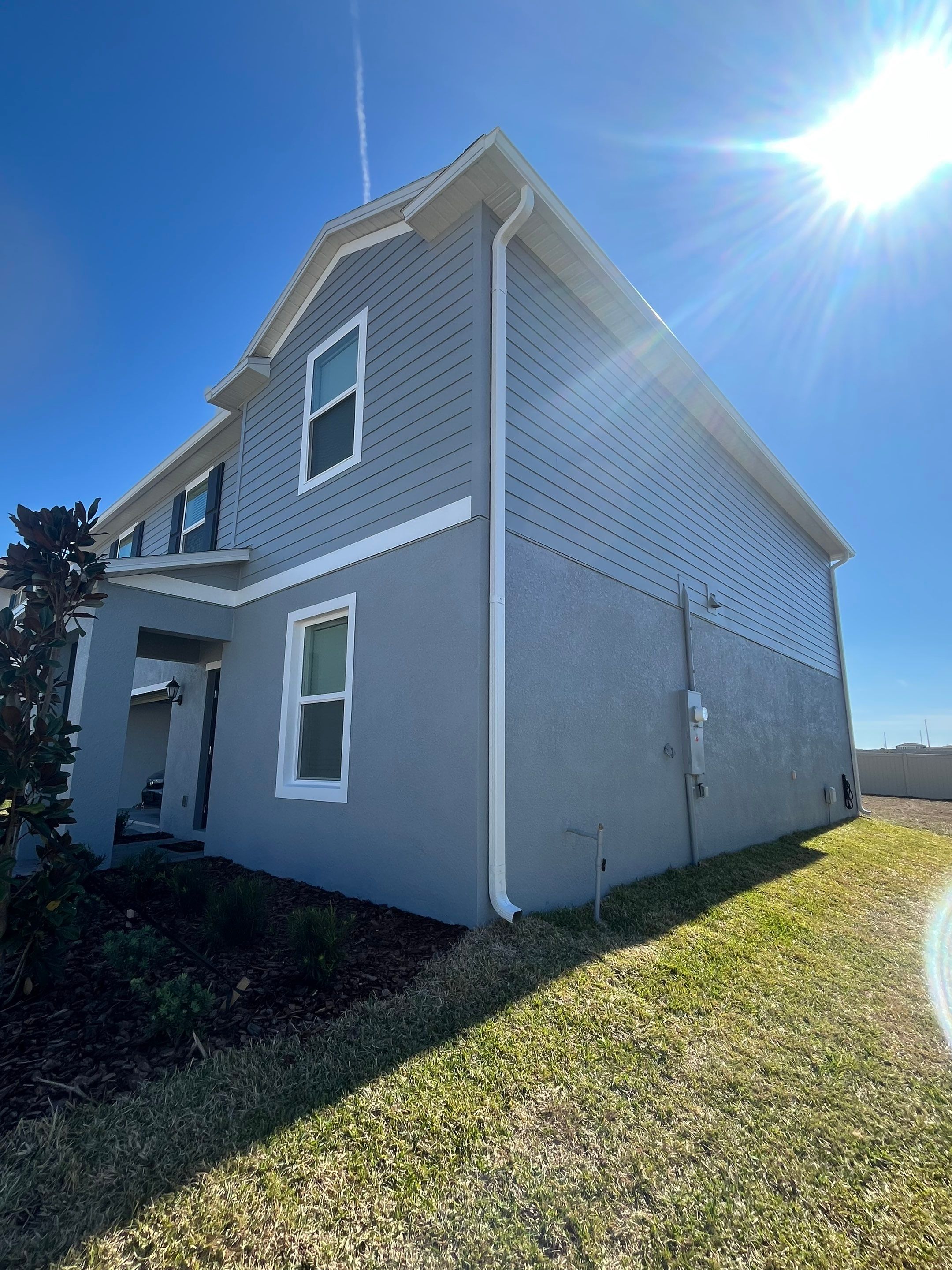 White Down Spouts and Seamless Gutters using downspouts in Dade City FL by Gutter Professors