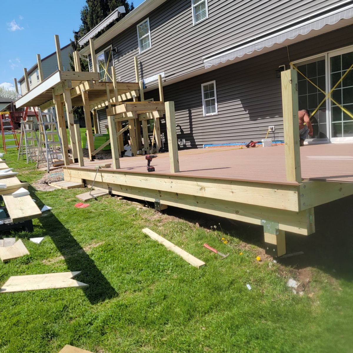 New Two Tier deck using Trex Hatteras boards and White Composite railings. by DiGiorgi Roofing and Siding Inc