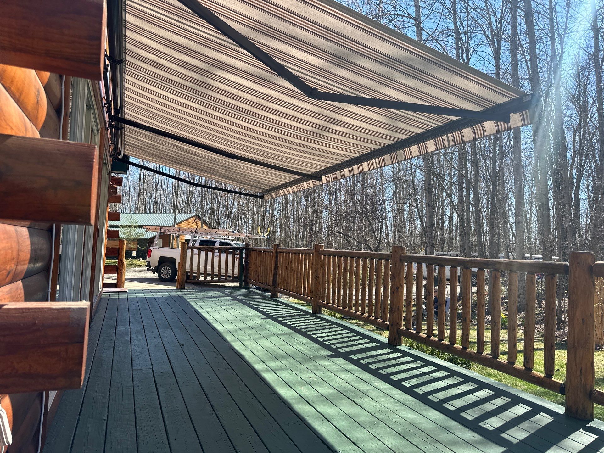 Retractable Awning Installation and Exterior Maintenance in Houghton Lake by Rainbow Seamless Systems