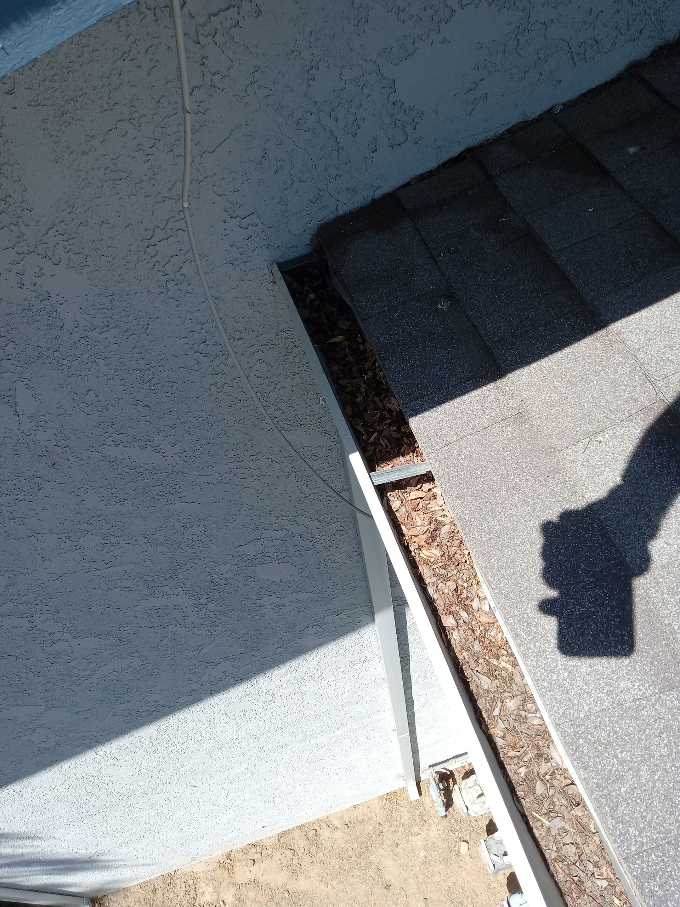 Commercial gutter cleaning Corcoran, CA before photo with filled gutters