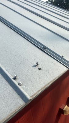 Metal roof panels on red building