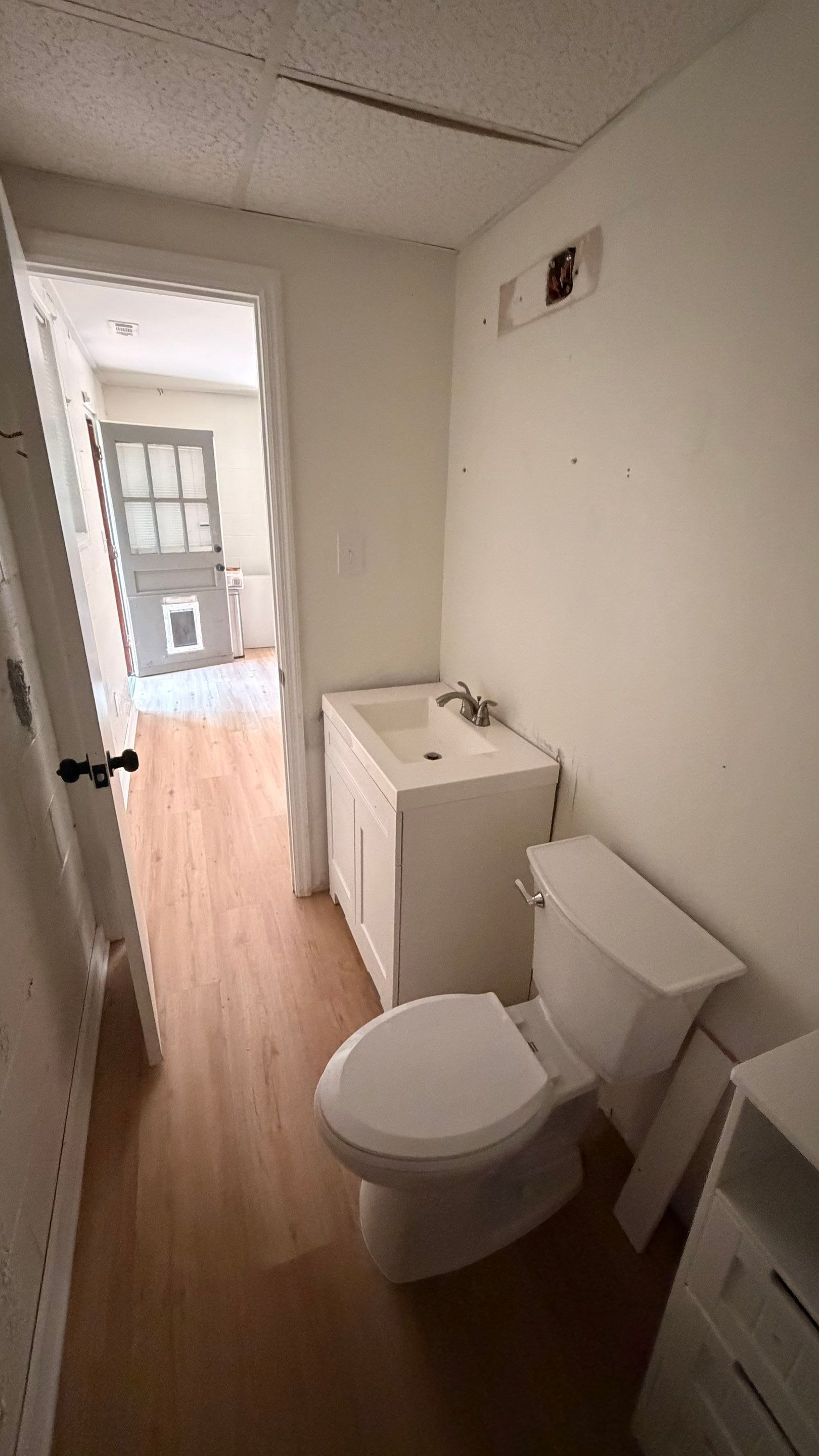 Basement Remodeling with Wood-Look Flooring and Custom Wainscoting in Dunwoody by Swift Home Renovations