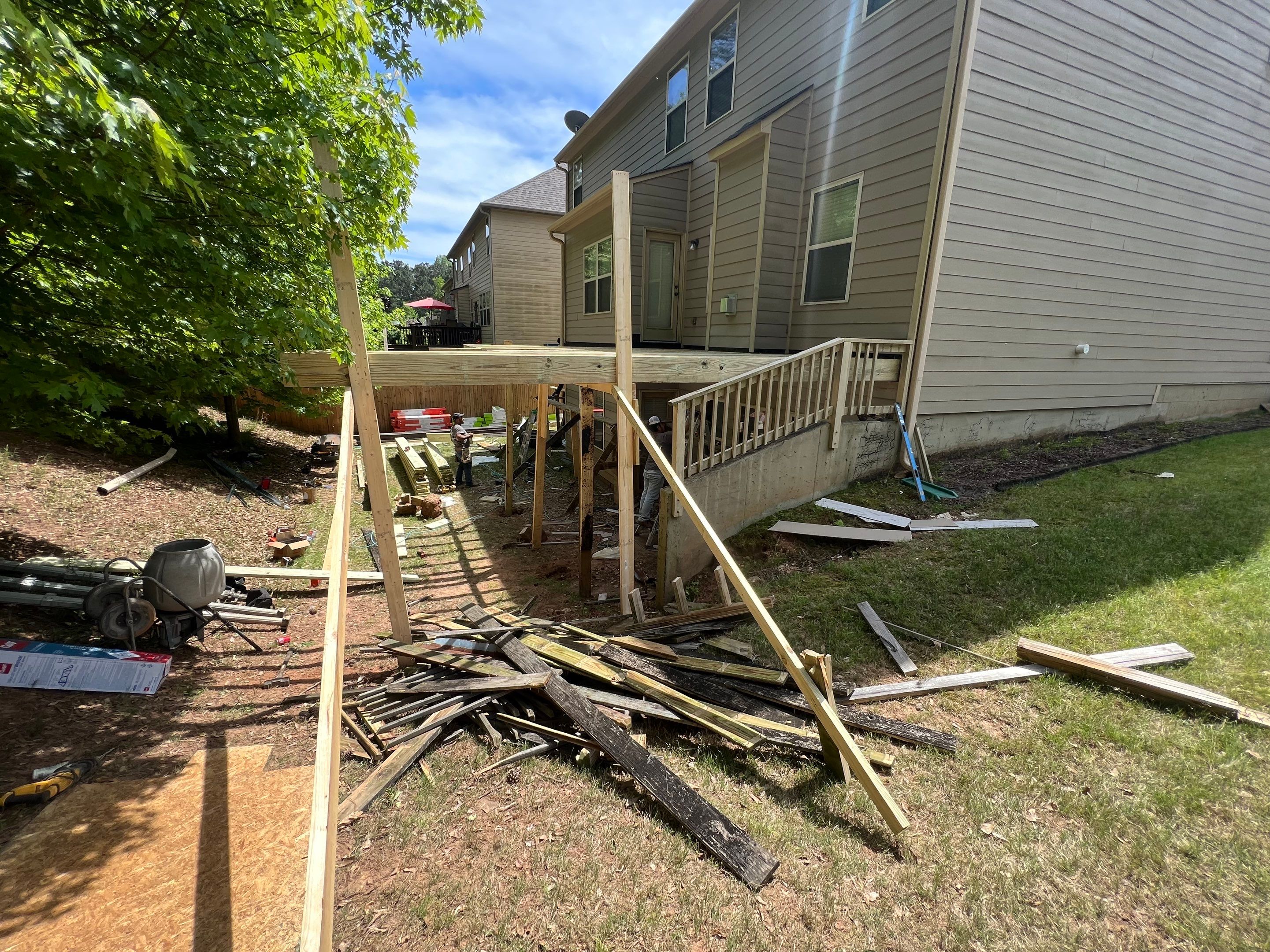 Custom Elevated Deck Replacement with White and Black Railings by Swift Home Renovations