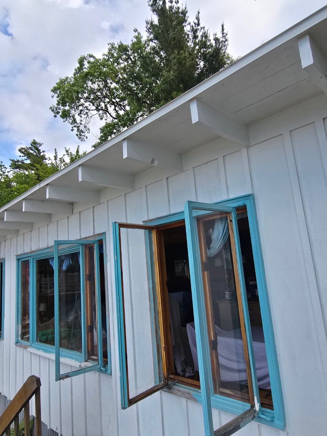 Lakeside Cottage Exterior Painting and Teal Trim Restoration in Mears by Gordon Painting