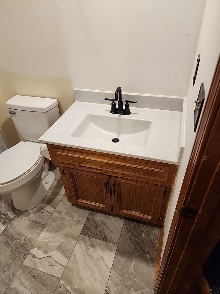 Bathtub, door, toilet, flooring, and countertop by The Shower Company